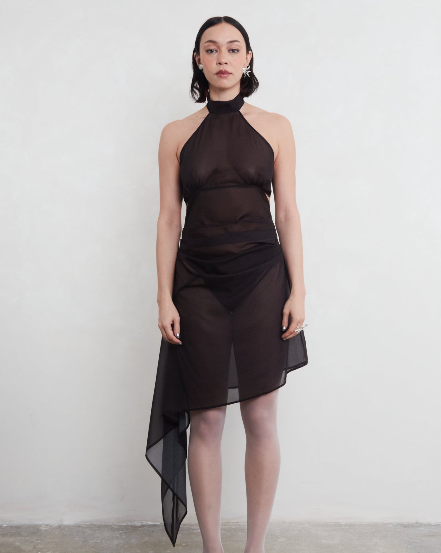 Model wearing a black sustainable deadstock dress against a white background