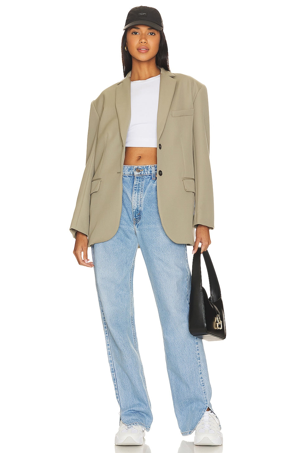 Model wearing a tilted split customs in a white background. 100% made from repurposed Levi’s.