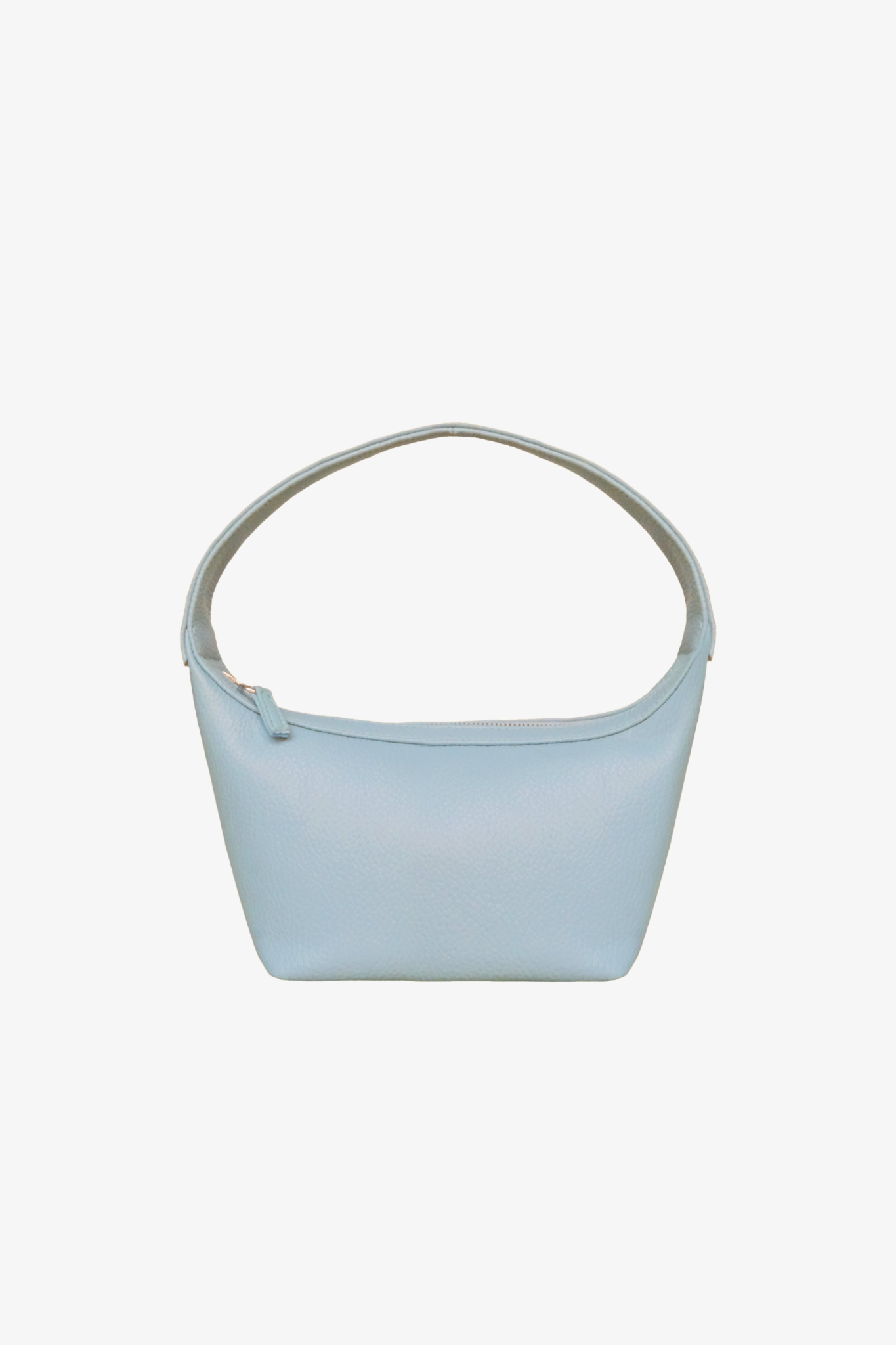 Light blue sustainable handbag made from cactus leather with a strap on a white background. Front view.