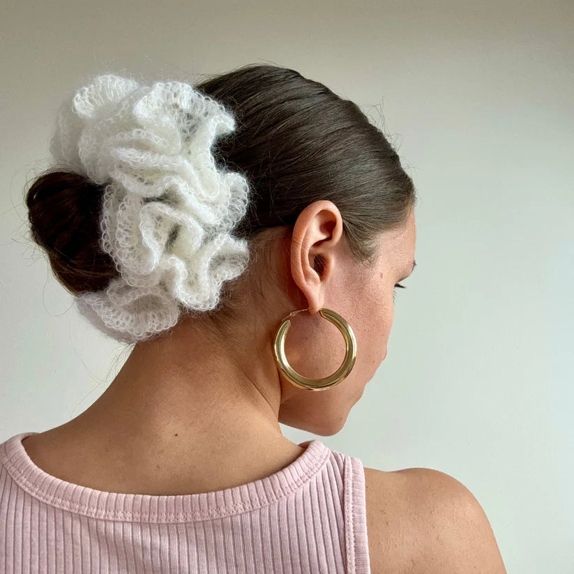 A model wearing the anna scrunchie in a white background. Handmade in London!