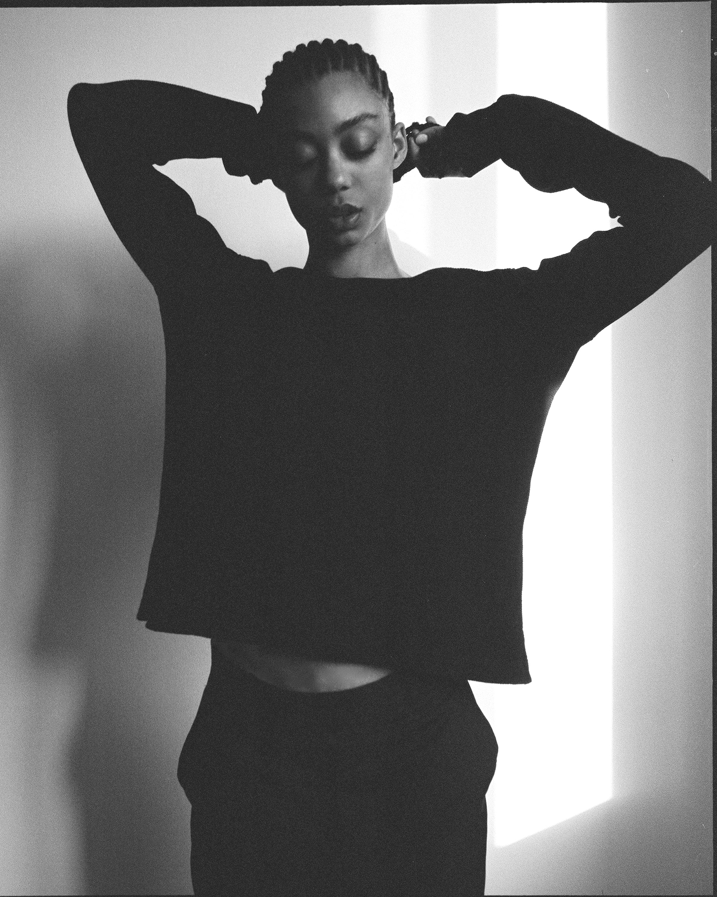 A model wearing the black anthony waffle l/s in an aesthetically background. 100% made from organic grown cotton.