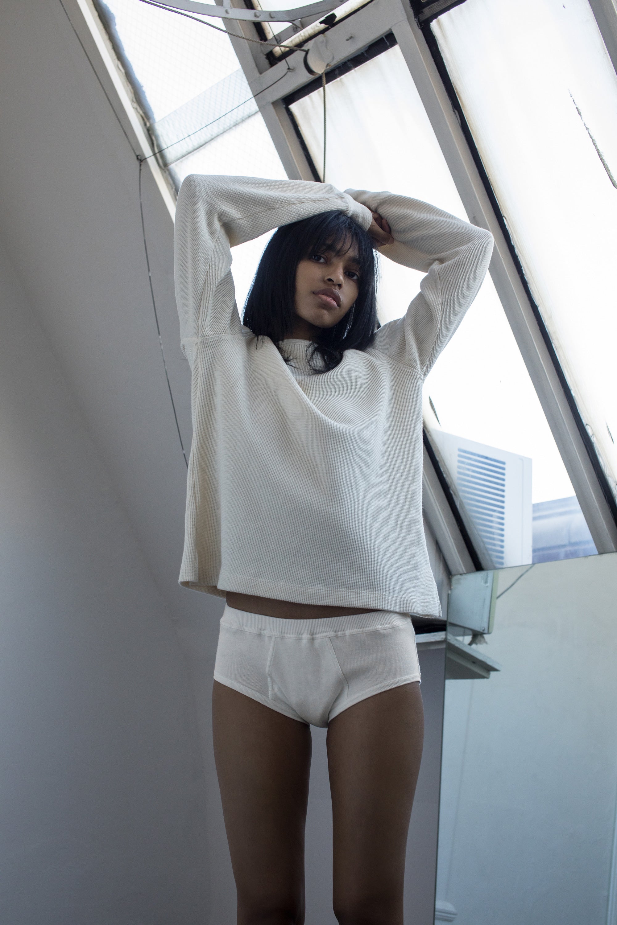 A model wearing the natural anthony waffle l/s in an aesthetically background. 100% made from organic grown cotton.
