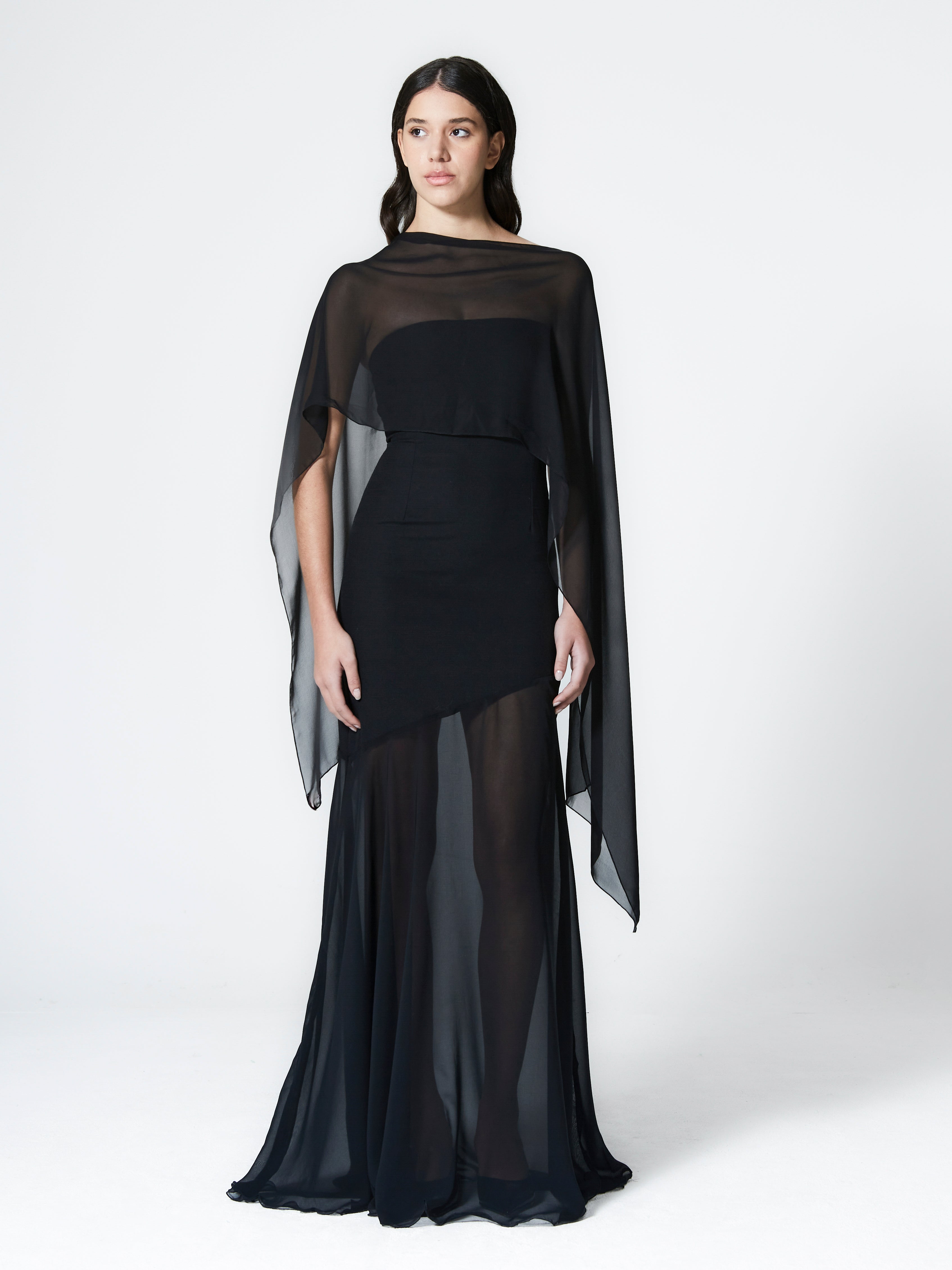 A model wearing the aria gown in a white background. Made from deadstock wool paired with deadstock soft sheer viscose chiffon