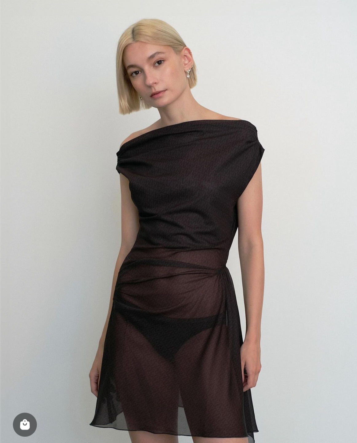 Model wearing a black dress against a white background. Made from sustainable deadstock materials.