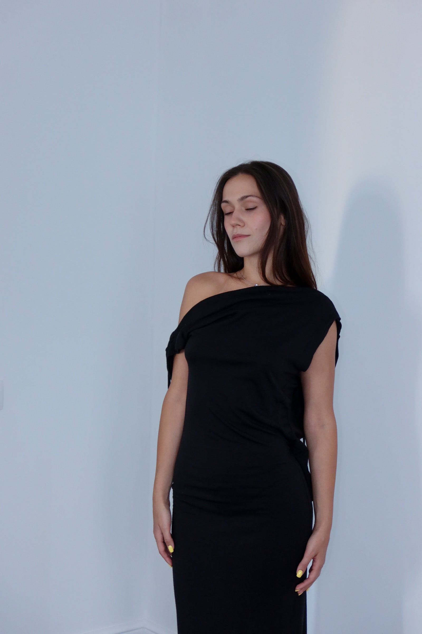 A model wearing the axis silk jersey dress in a white background. 100% made from deadstock.