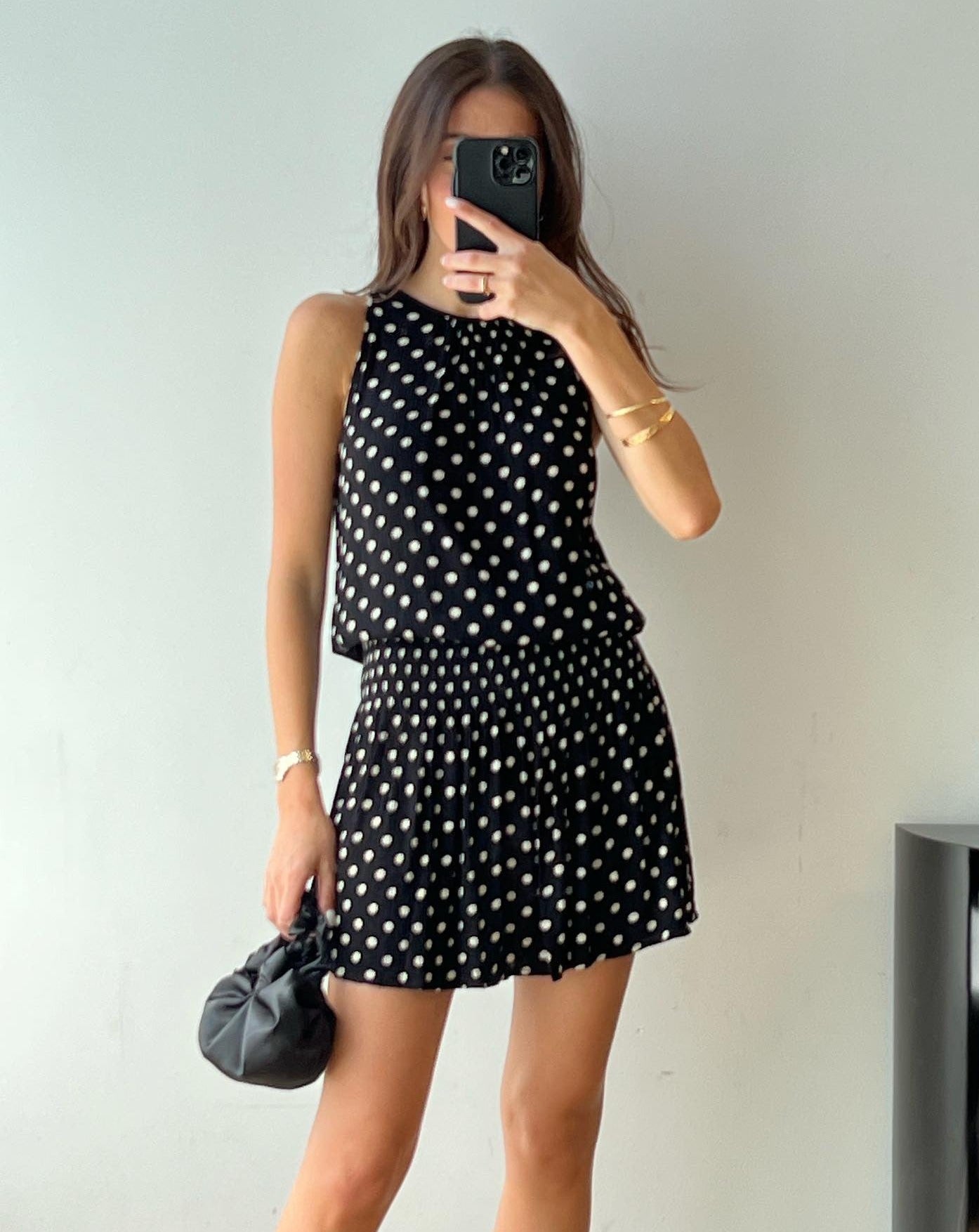 A model wearing the black silk knot bag in a white background. Deadstock silky satin fabric sourced in Los Angeles.