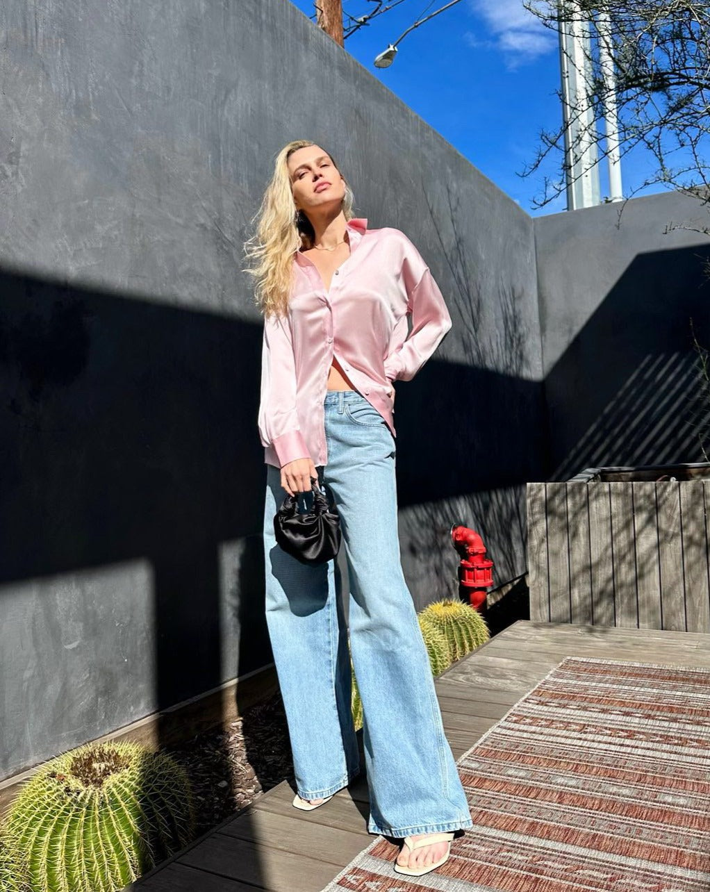 A model wearing the black silk knot bag. Deadstock silky satin fabric sourced in Los Angeles.