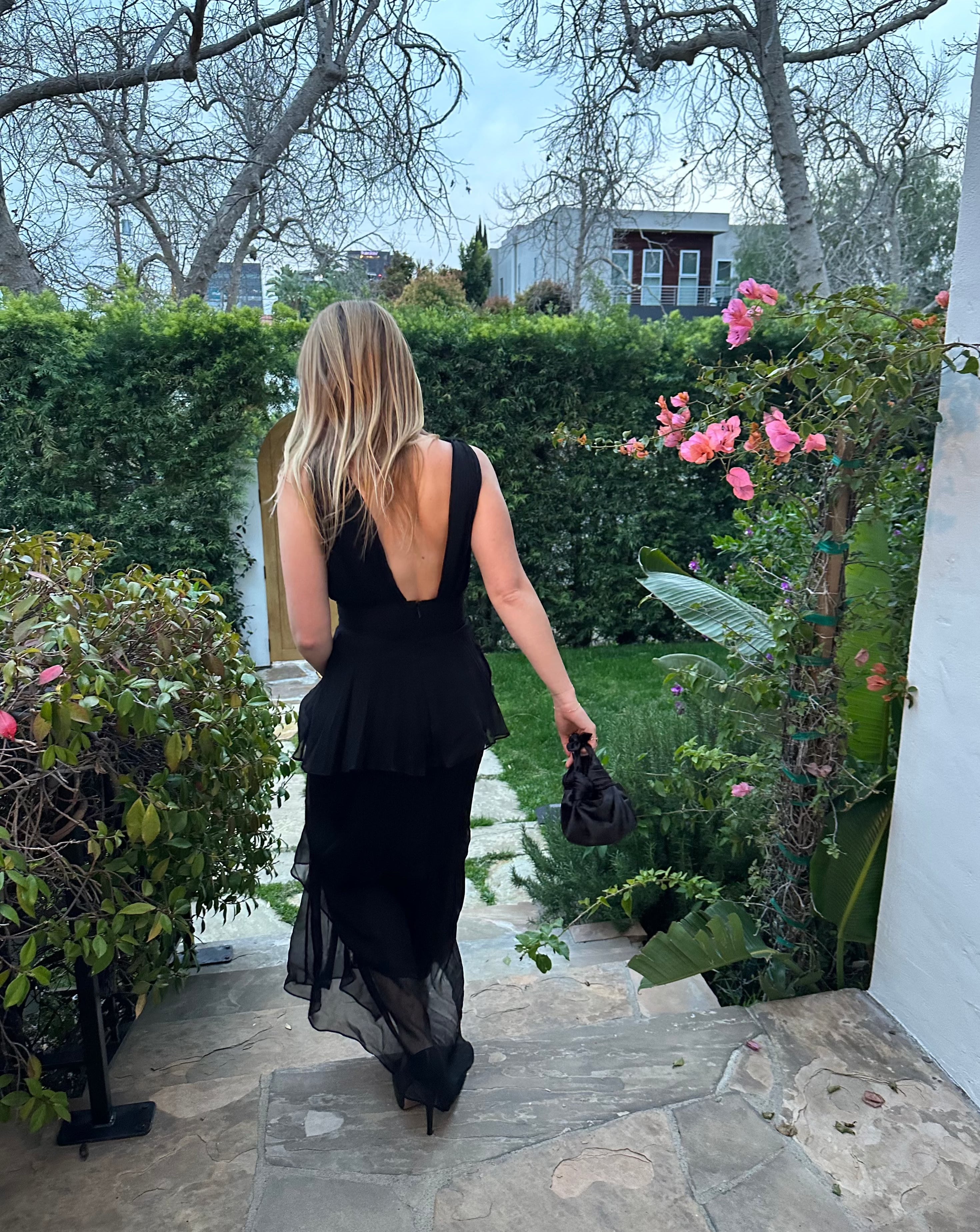 A model wearing the black silk knot bag. Deadstock silky satin fabric sourced in Los Angeles.