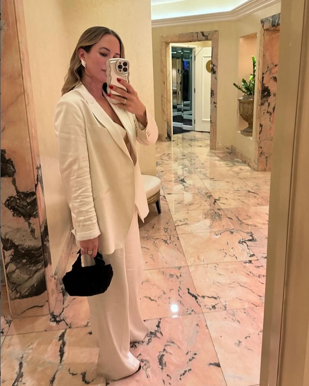 A model wearing the black silk knot bag. Deadstock silky satin fabric sourced in Los Angeles.