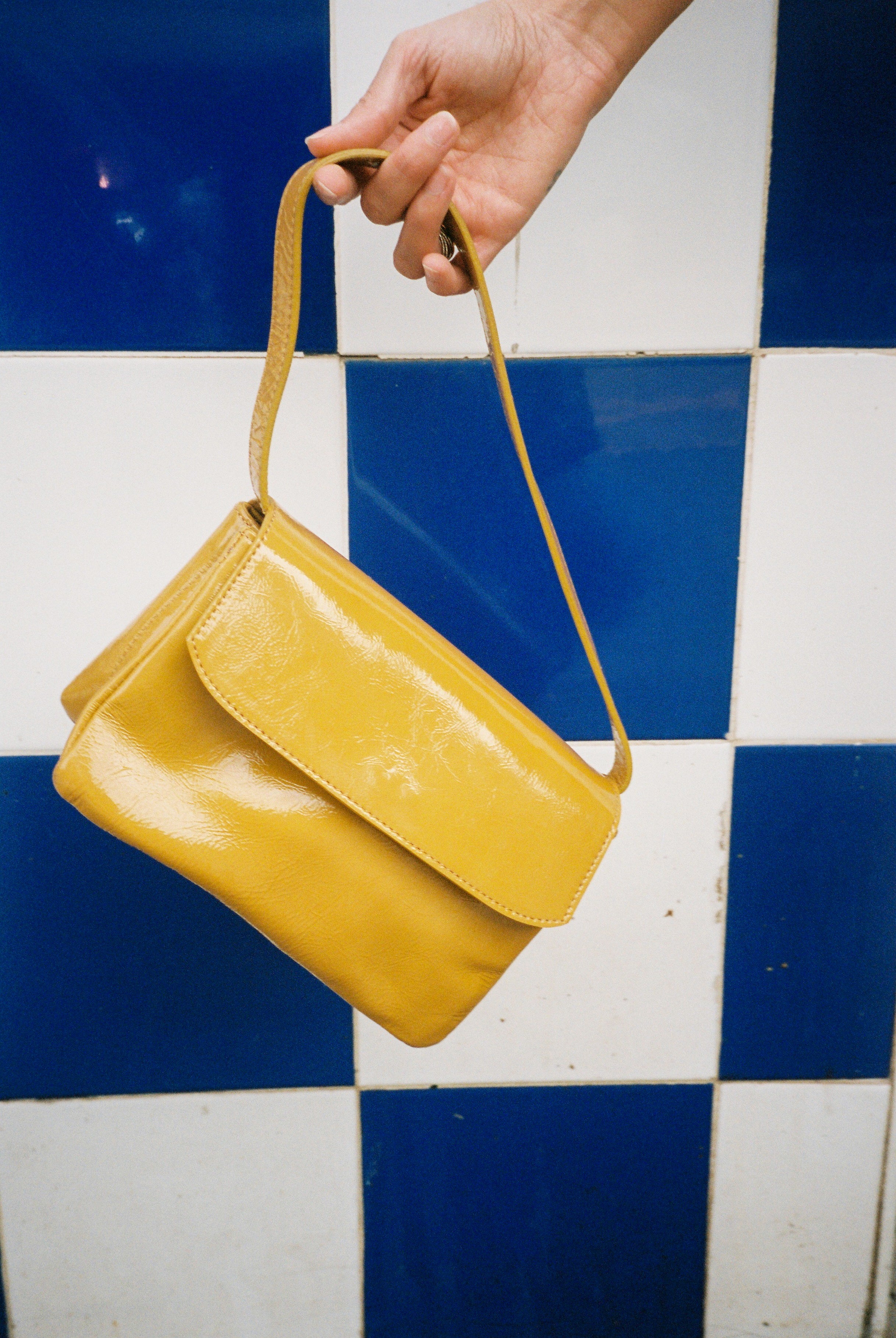The babe mustard bag in an aesthetically background. 100% made from deadstock leather.