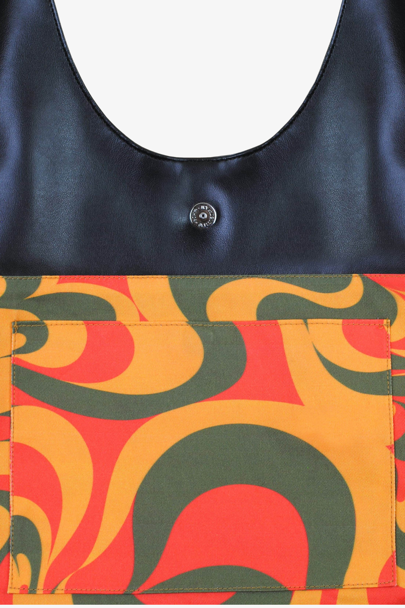 Close-up of a cactus leather bag with a colorful pattern and black top section.