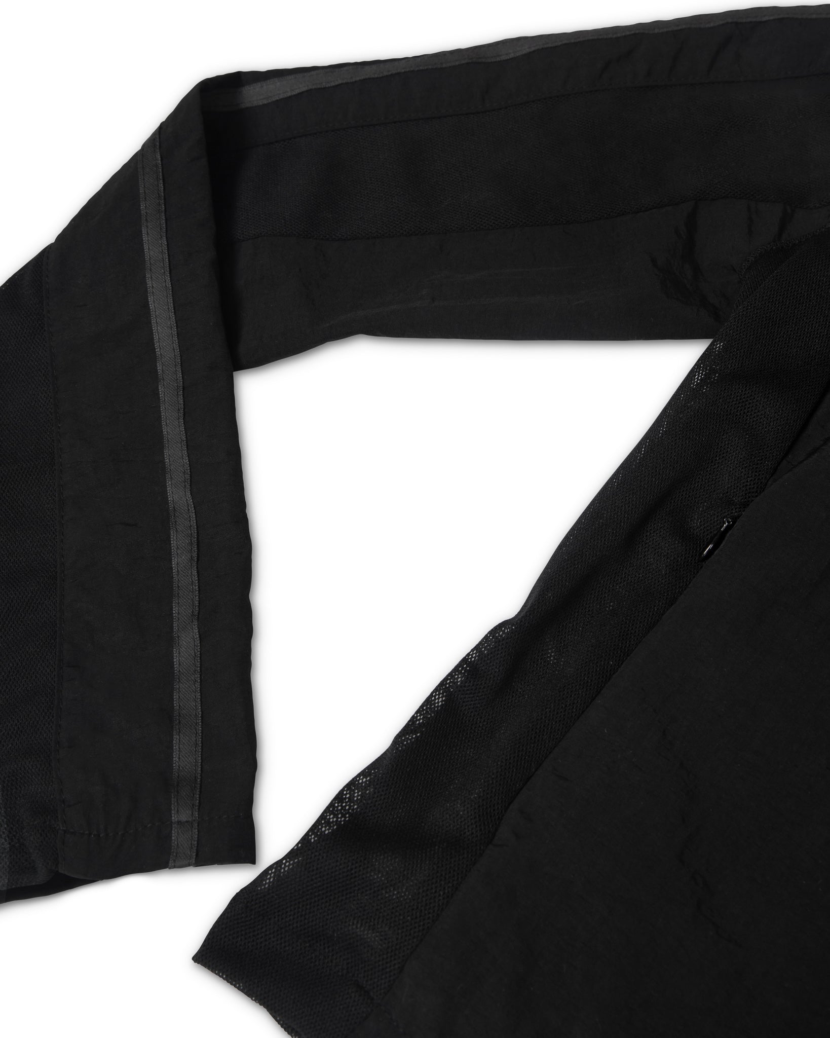 Black deadstock mesh fabric with a subtle pattern on a jacket with white background.