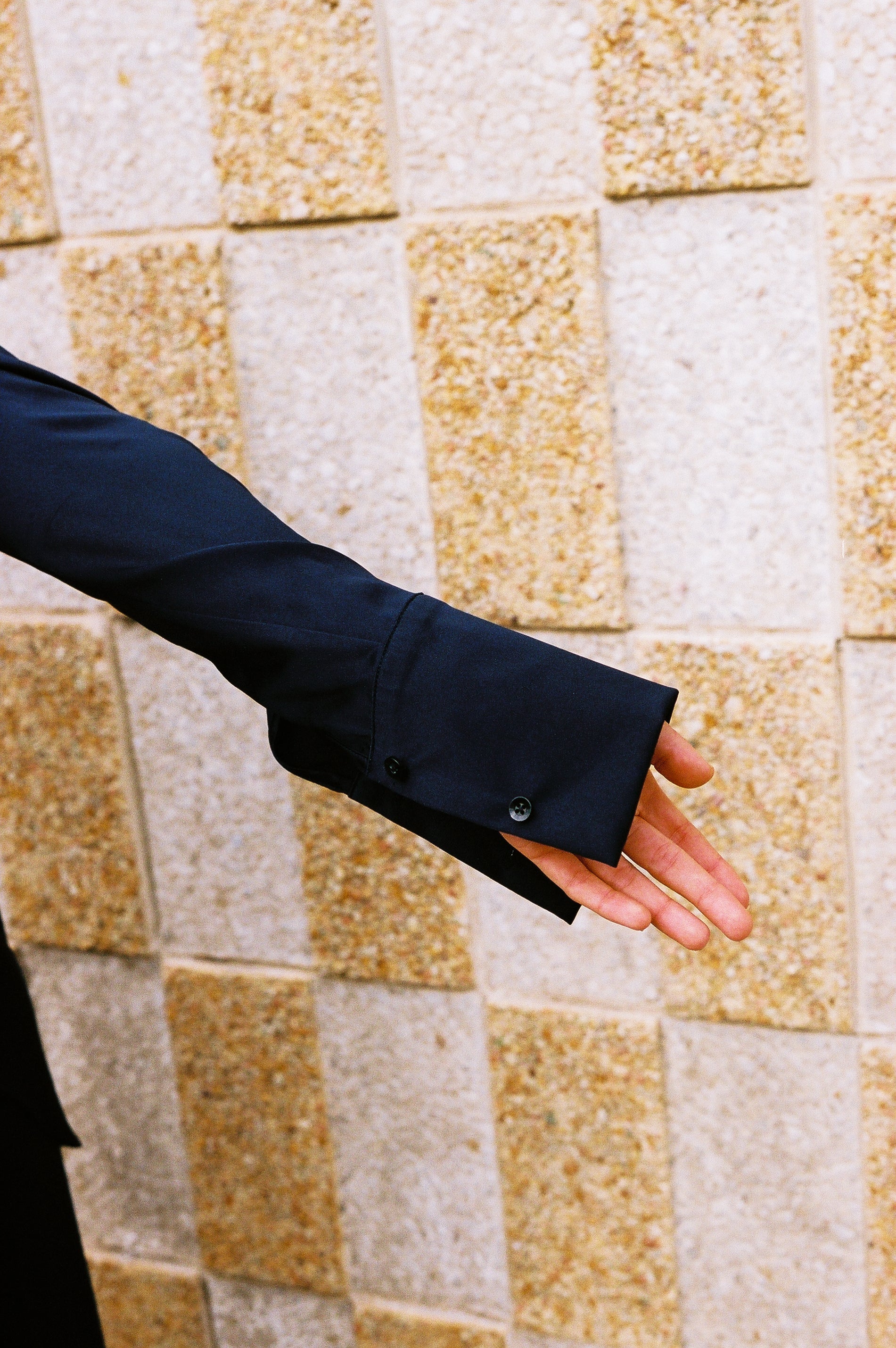 girl standing up wearing roma silk pants and borro silk button up in navy