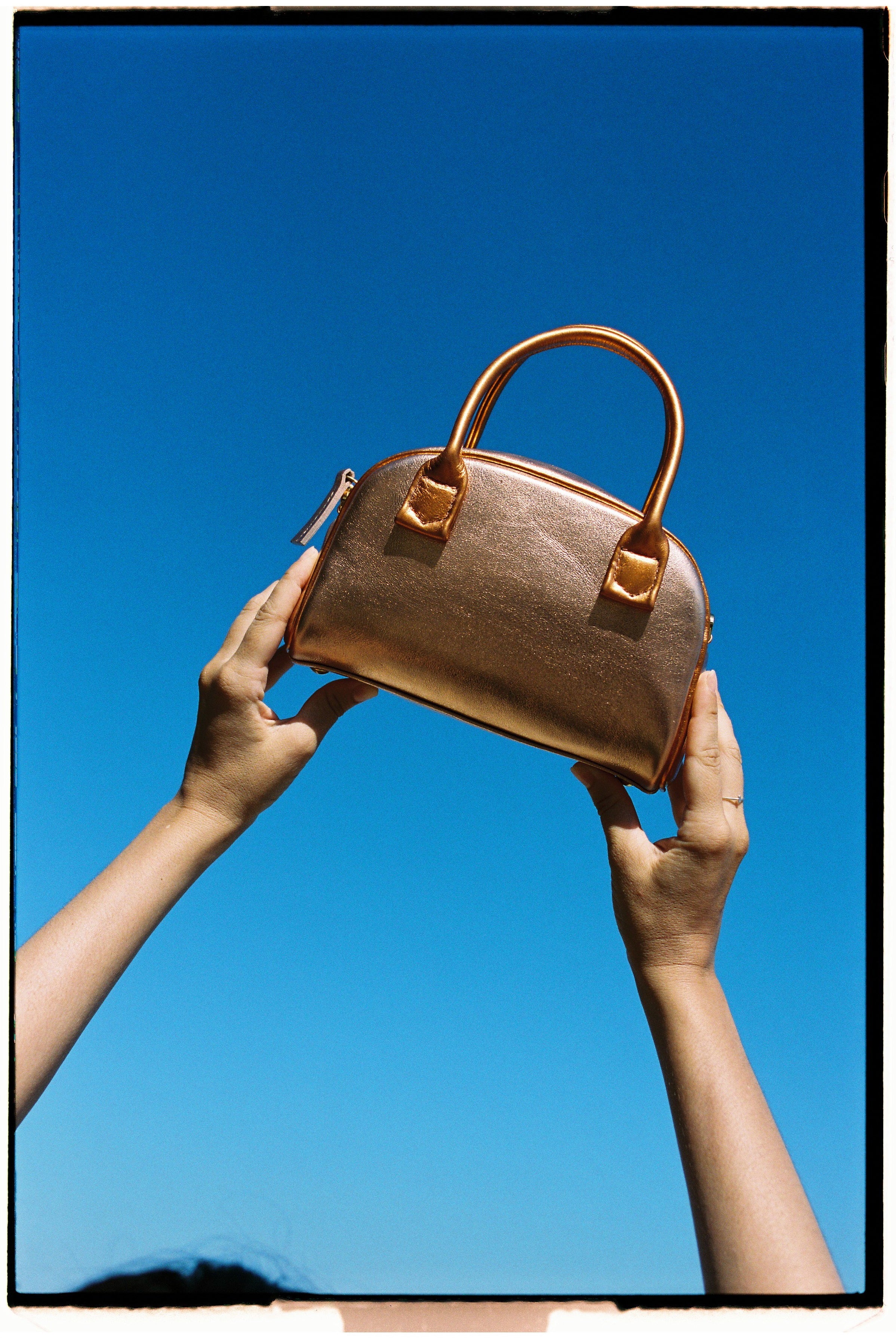 The bowling tropico bag in an aesthetically background. 100% made from deadstock leather.