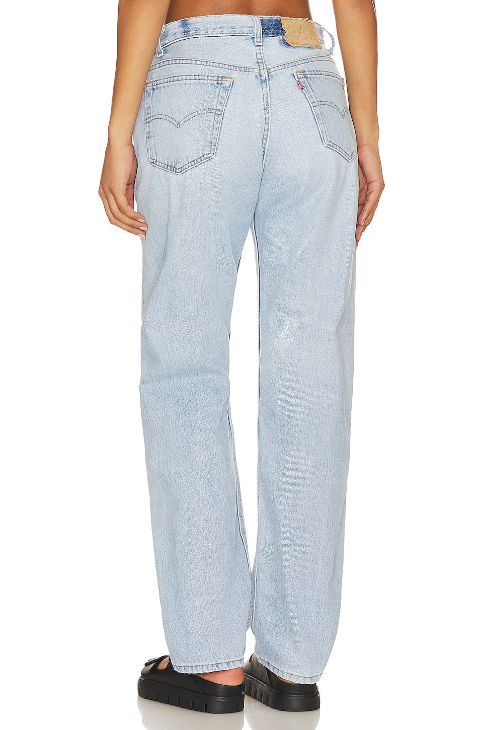 Model wearing the Brigette baggy customs in a white background. 100% made from repurposed Levi’s.