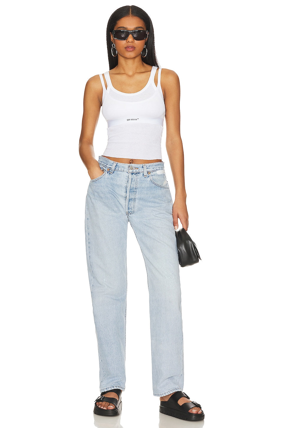 Model wearing the Brigette baggy customs in a white background. 100% made from repurposed Levi’s.