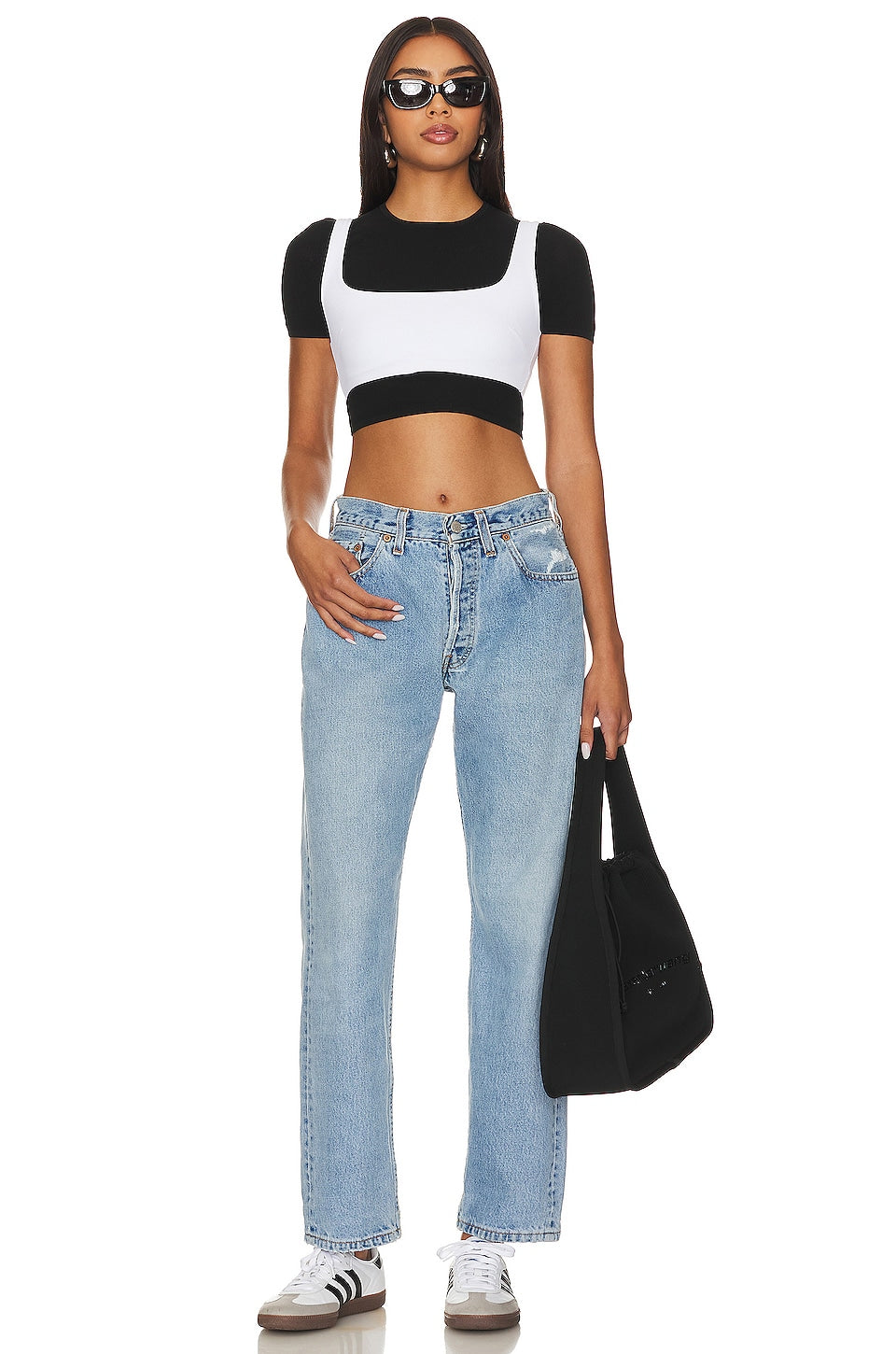 Model wearing the Brigette baggy customs in a white background. 100% made from repurposed Levi’s.