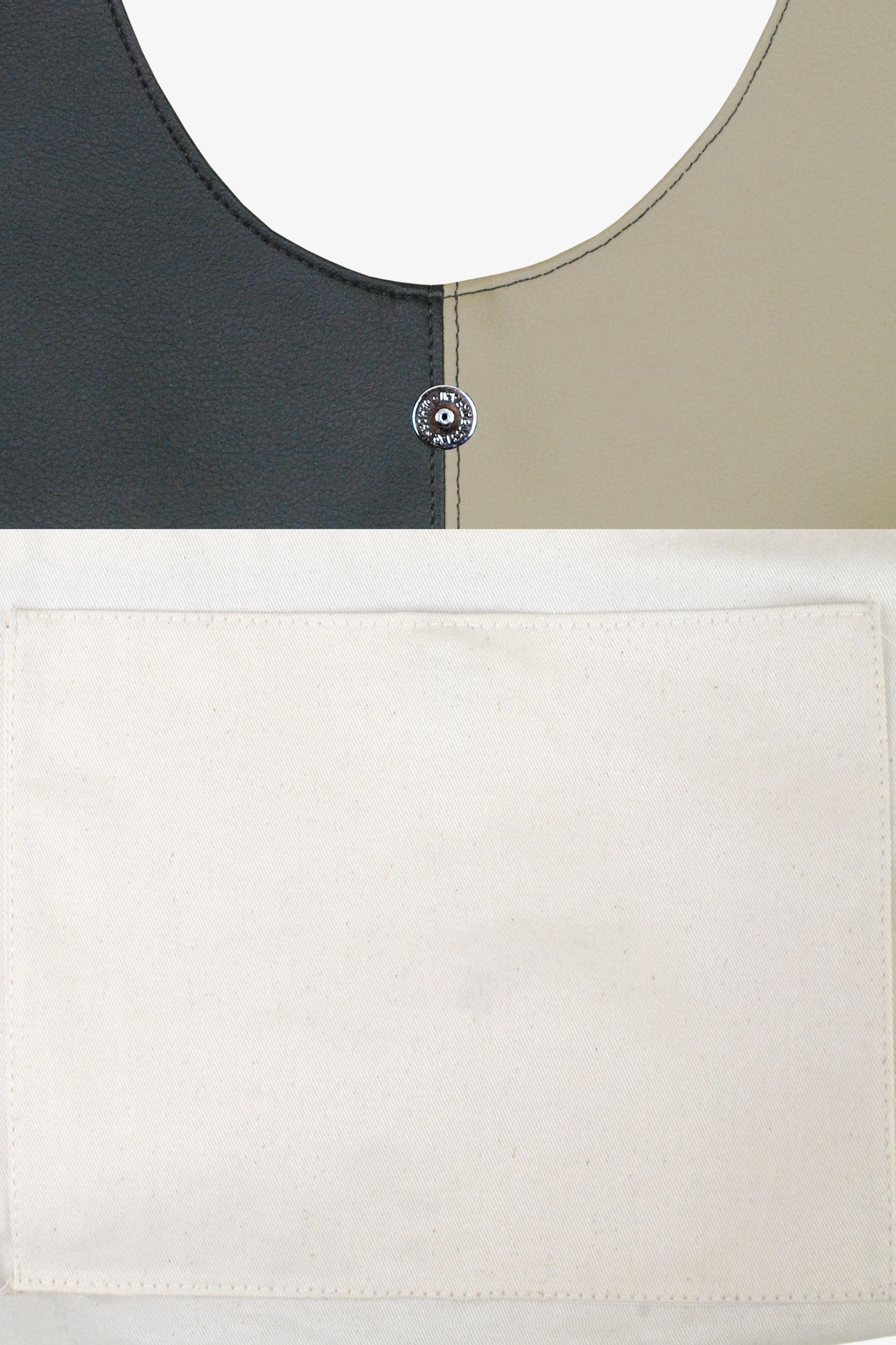 Close up image of a black and white handbag. Made from cactus leather and 100% organic cotton lining.