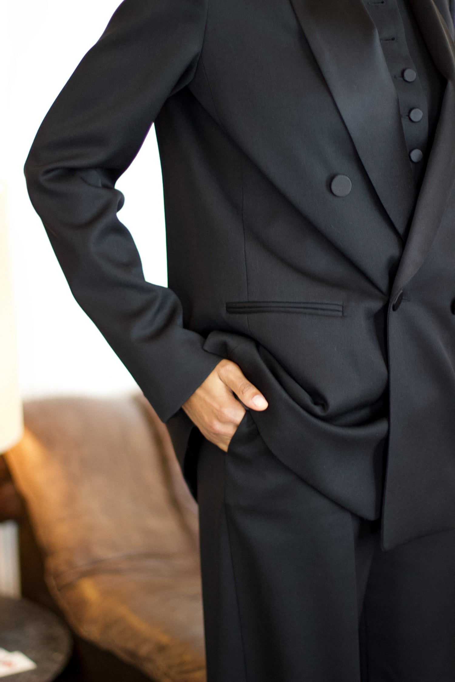 A model wearing the christy wool jacket with black satin collar in an aesthetically background. 100% made from upcycled wool and satin.