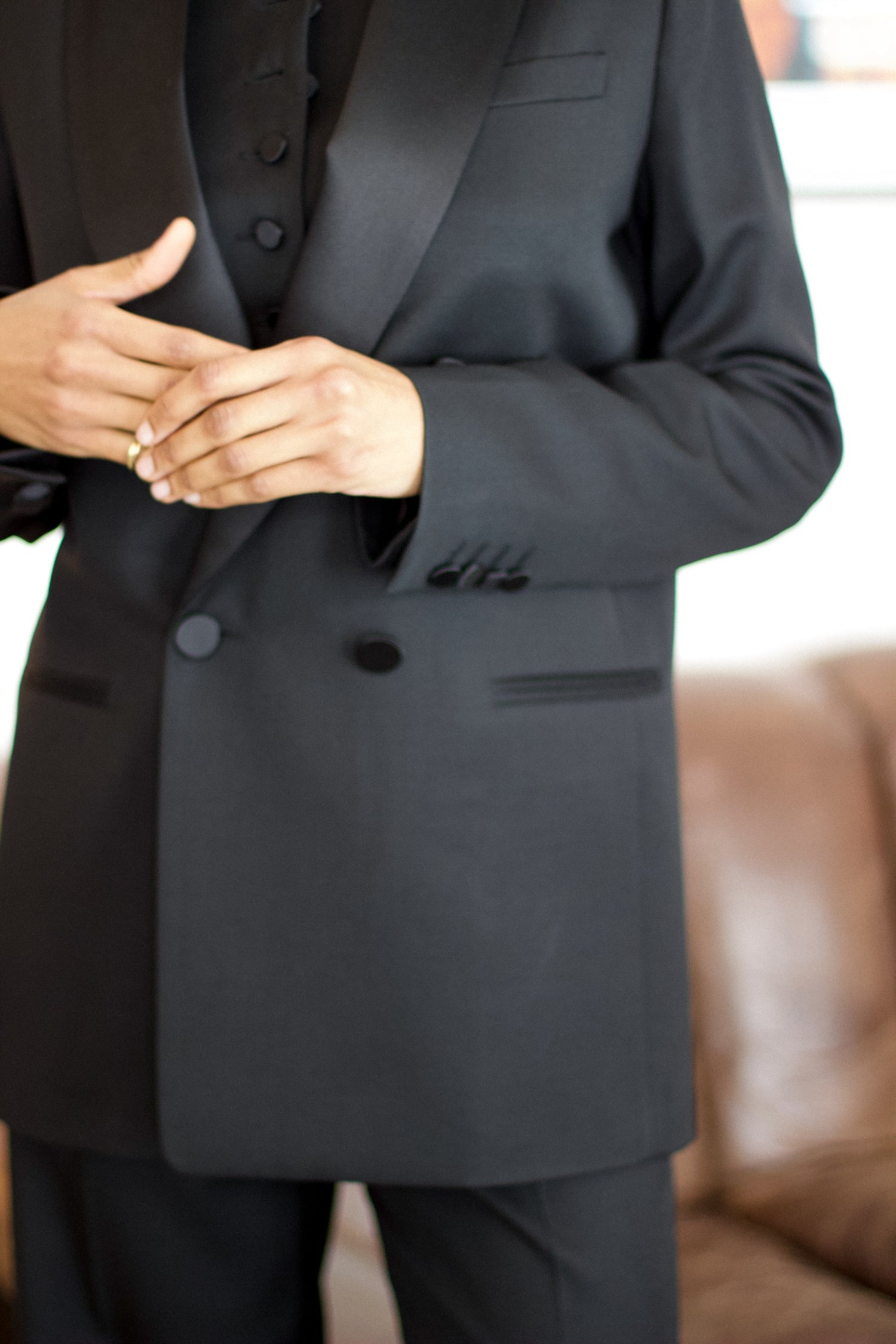 A model wearing the christy wool jacket with black satin collar in an aesthetically background. 100% made from upcycled wool and satin.