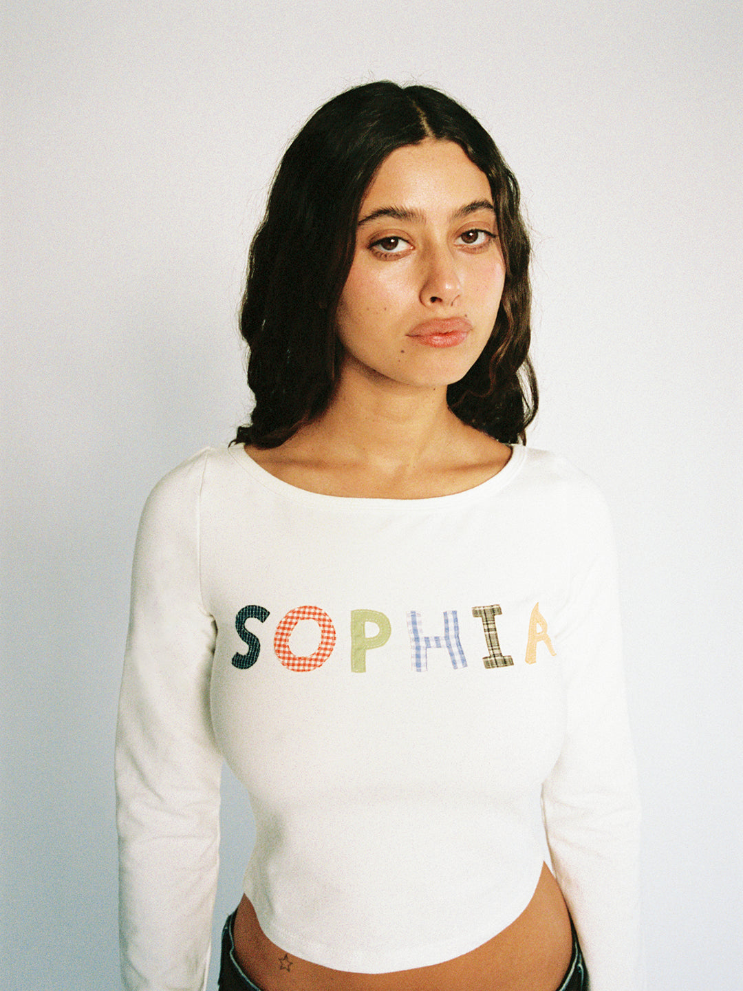 A model wearing the custom long sleeve in a white background. Made from certified organic cotton and deadstock.