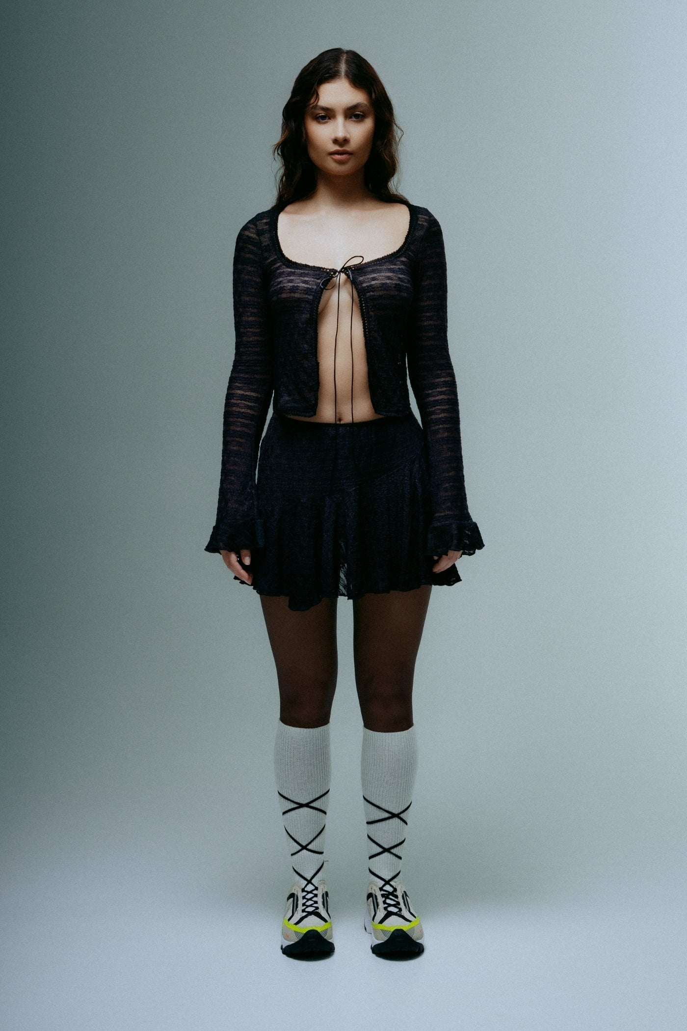 A model wearing the dreamlace top in a white background. 100% deadstock lace material.