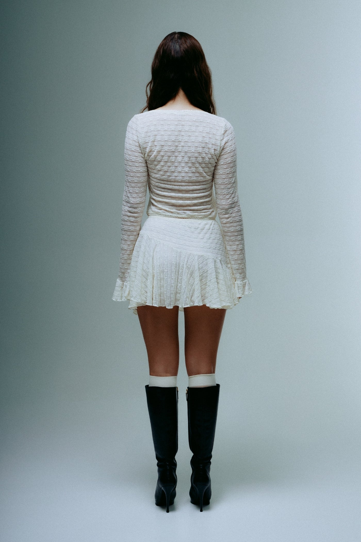 A model wearing the dreamlace top in a white background. 100% deadstock lace material.