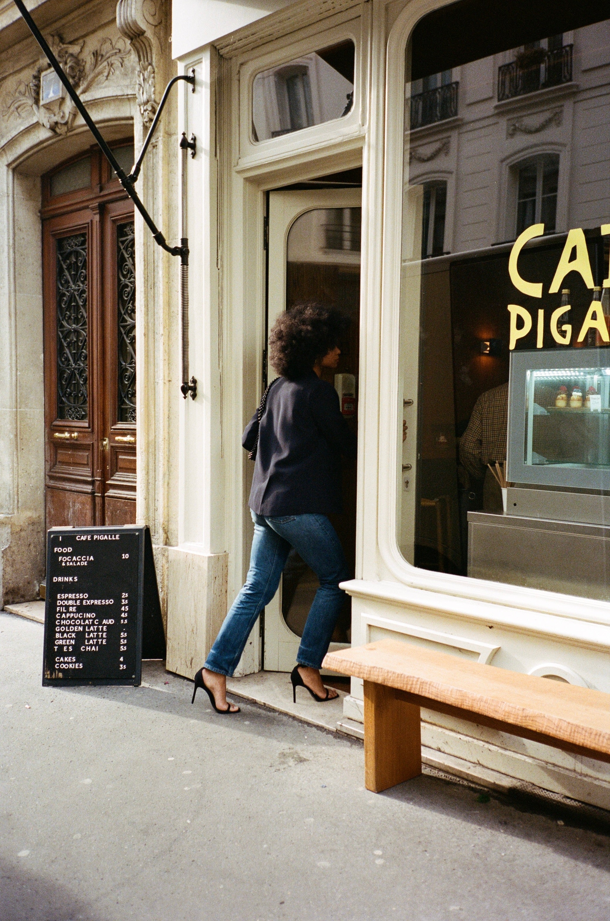 A model wearing the diana midnight blue blazer in an aesthetically outside background. 100% made from sustainable wool.