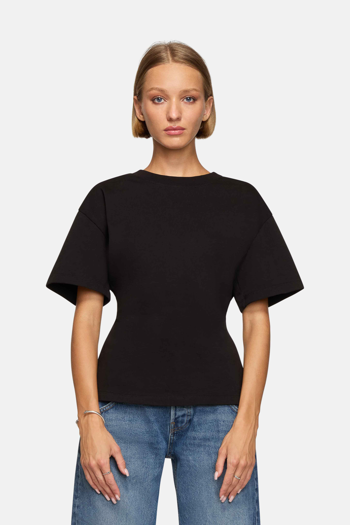 A model wearing the black eero tee in a white background. 100% made from cotton.