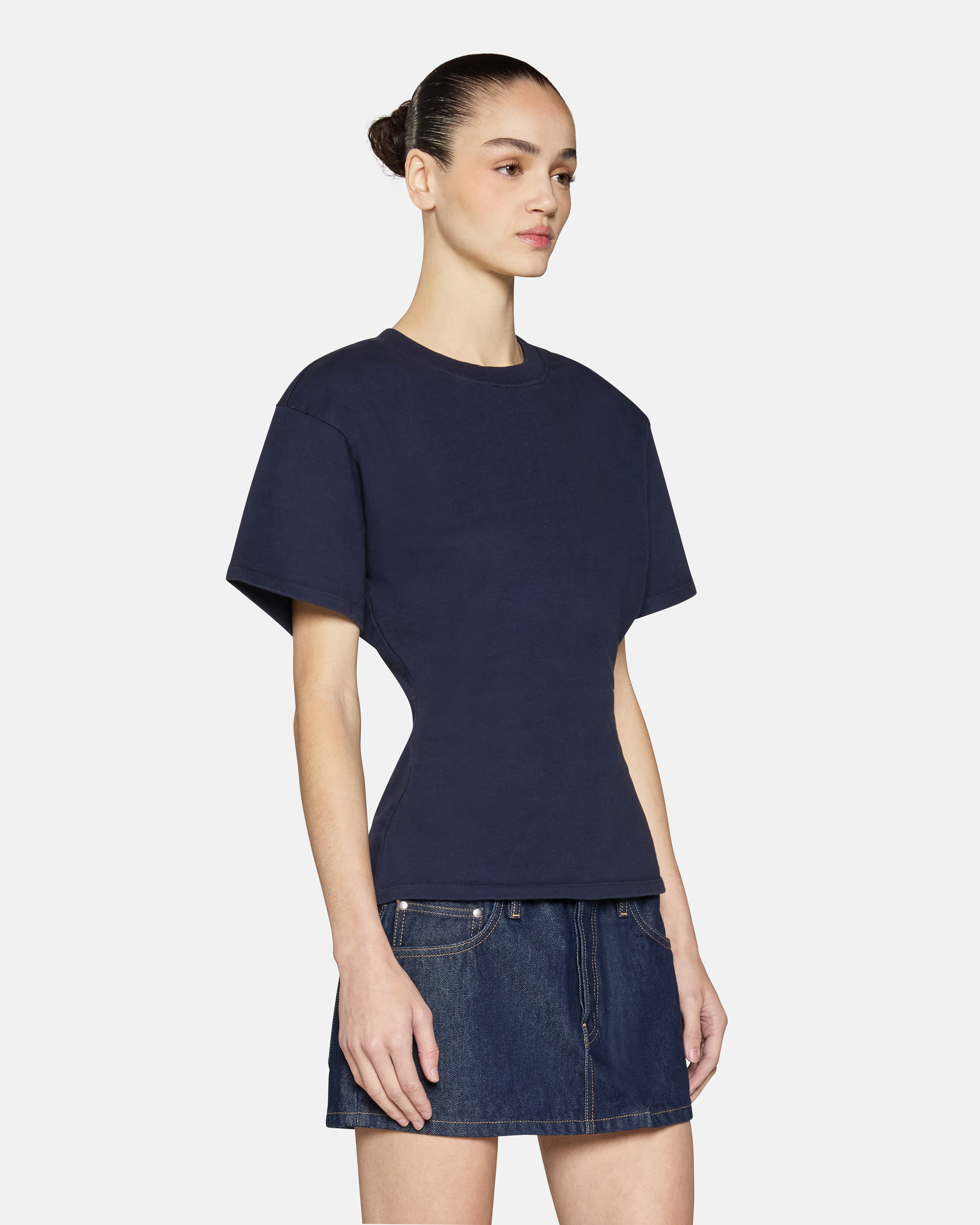 A model wearing the navy eero tee in a white background. 100% made from cotton.