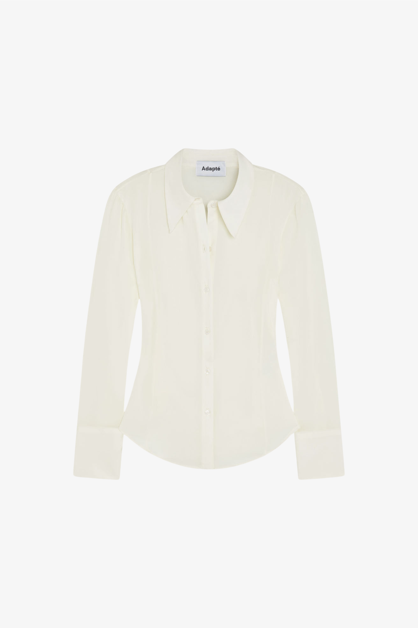 A silk ivory long sleeve button up blouse in a white background. Made from sustainable materials.