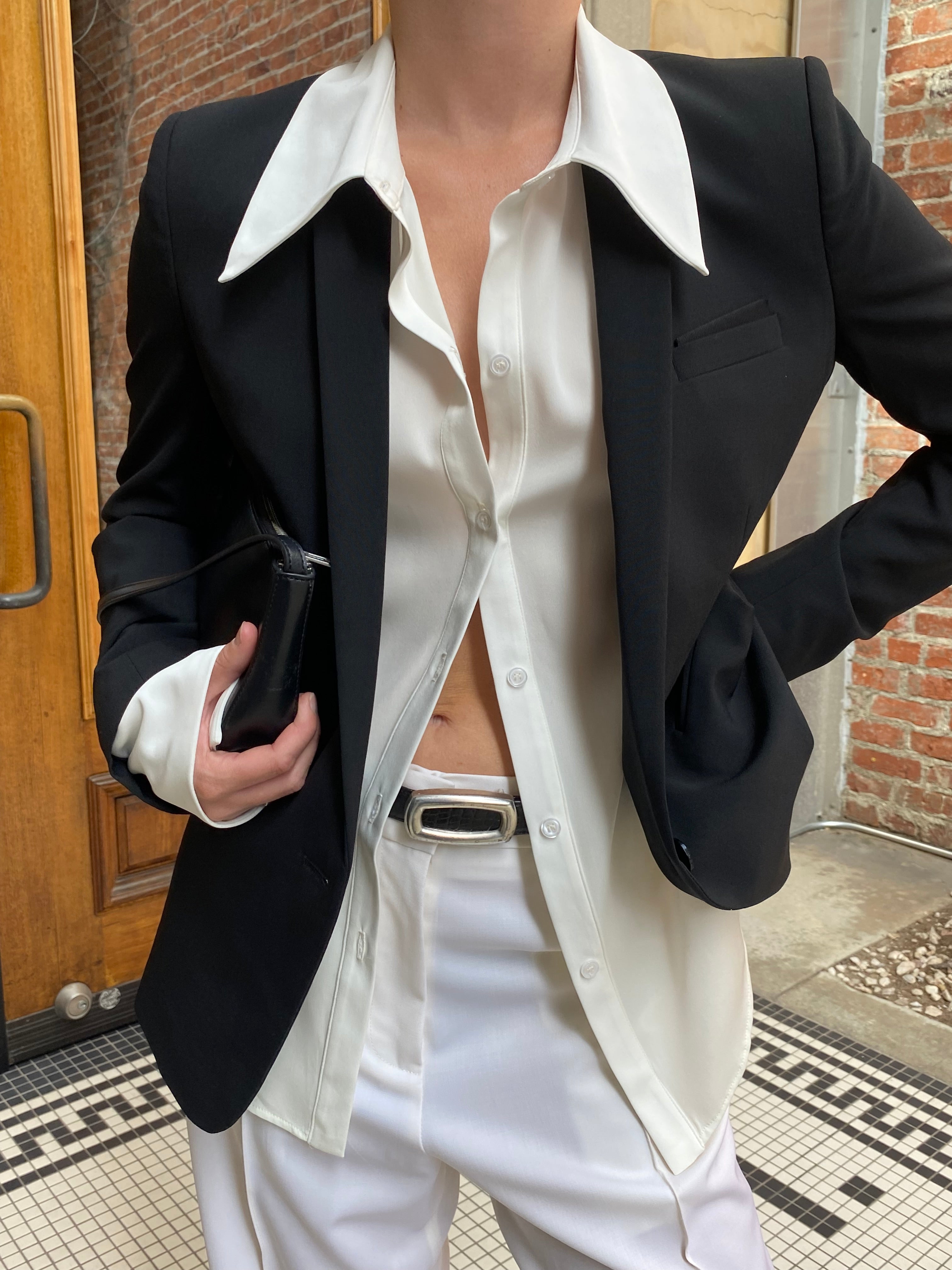 Close-up of silk ivory long sleeve button up blouse. Made from sustainable materials.