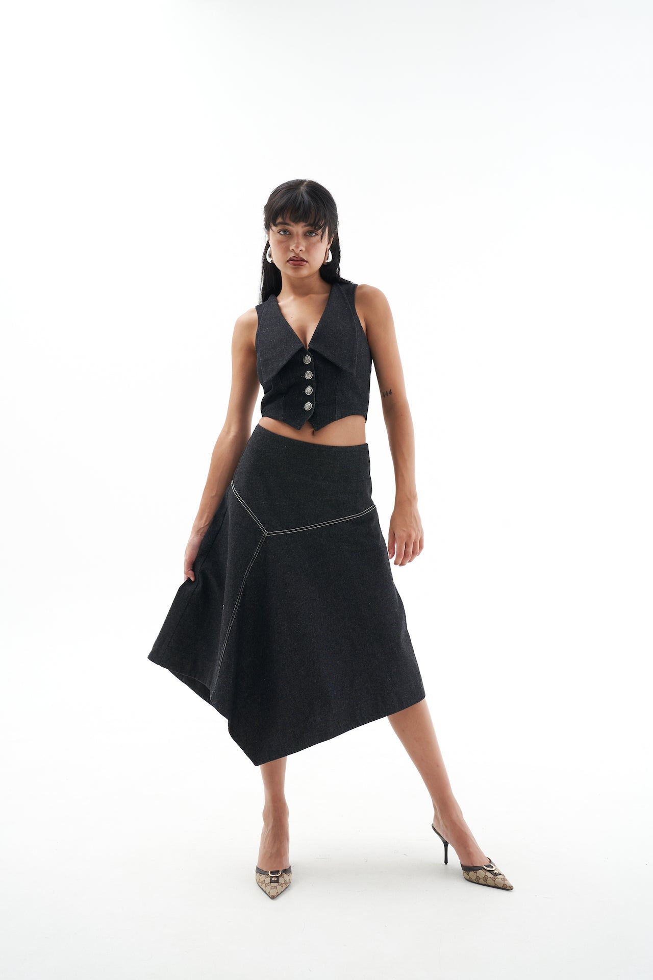 A model wearing the Genevieve skirt in a white background. 100% made from sustainable materials.