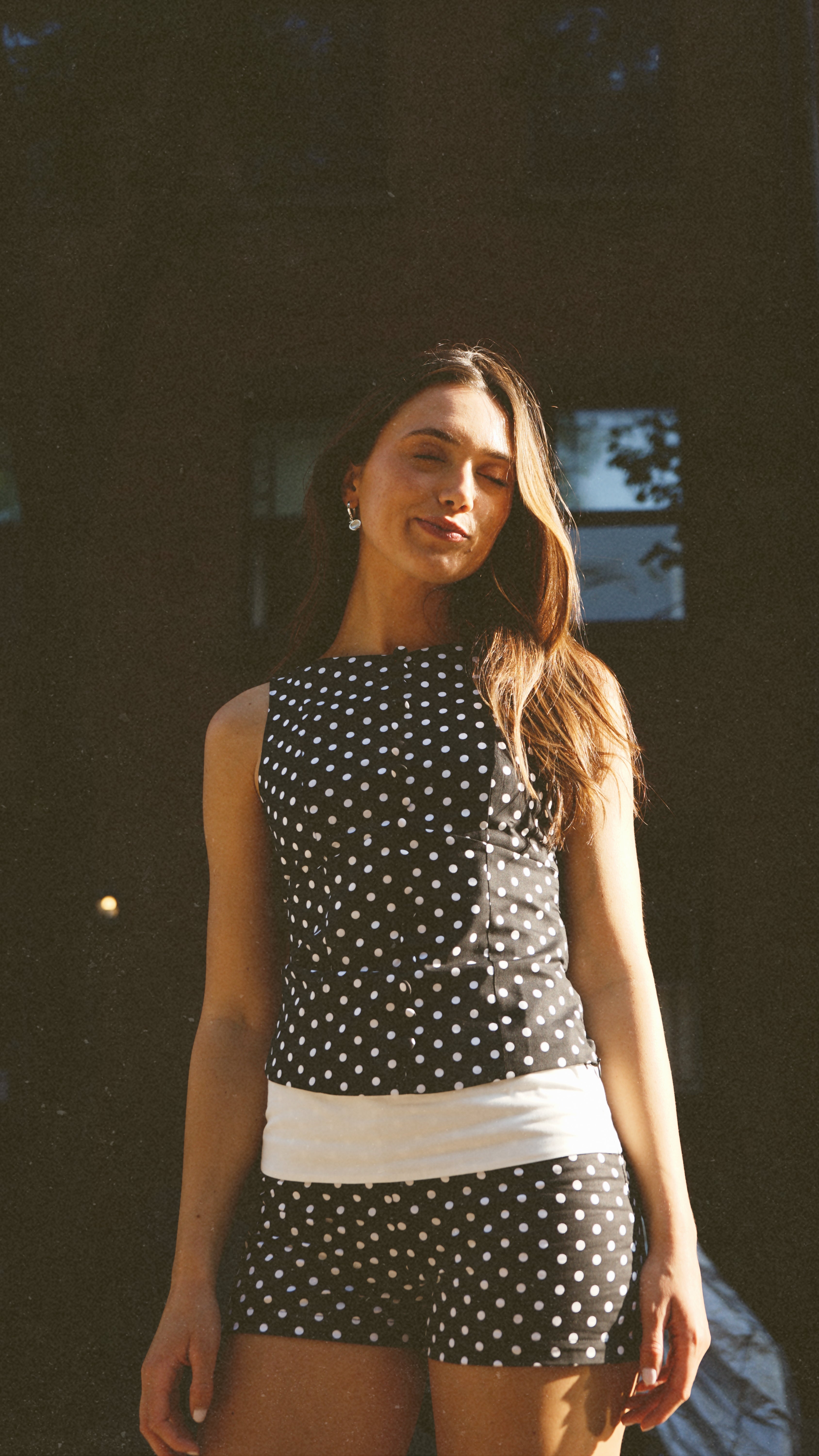 A model wearing the Georgie fold over short in an aesthetically background. 100% made from deadstock sustainable cotton.