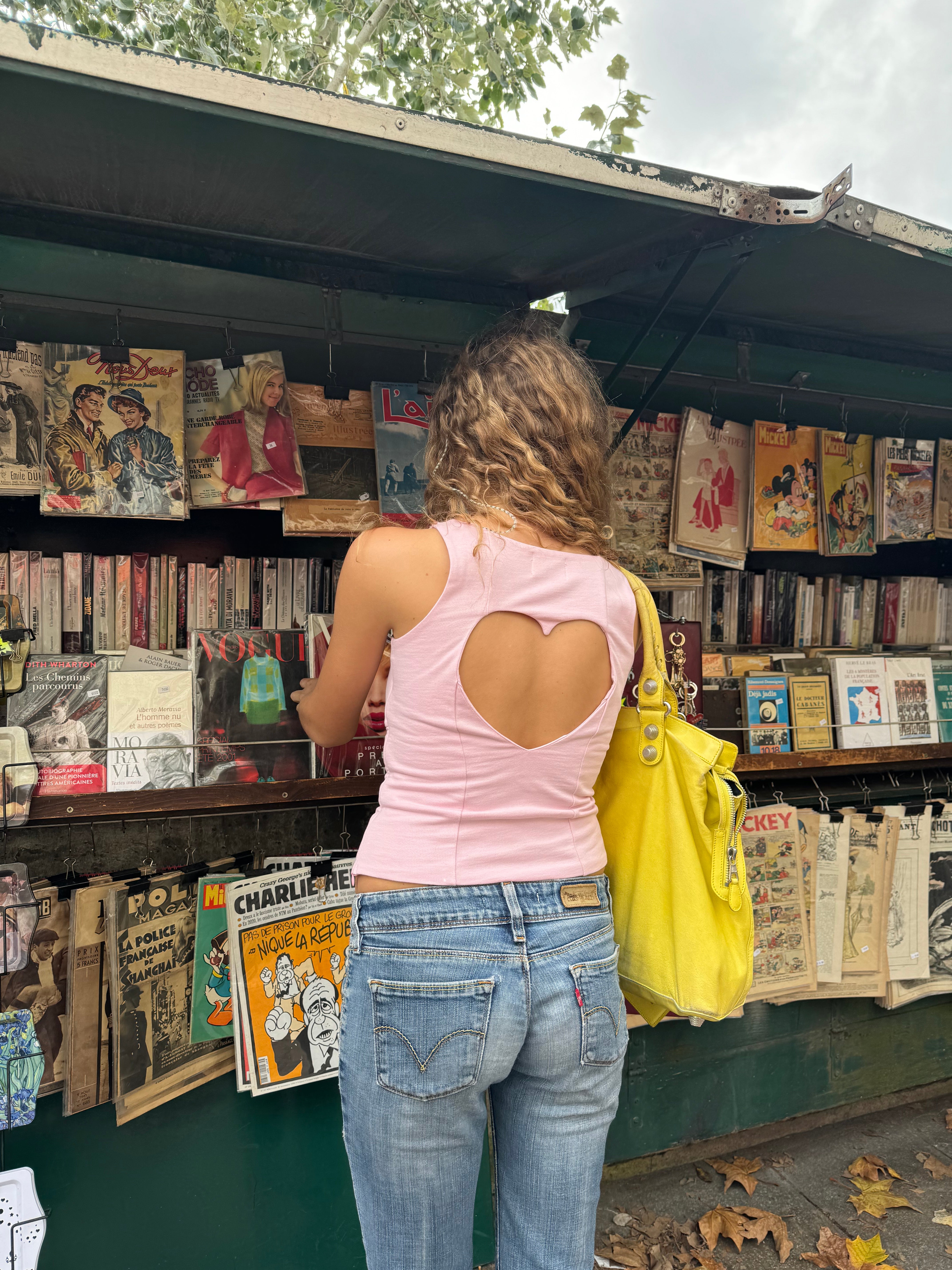 A model wearing the pink Georgie top in an aesthetically background. 100% made from deadstock sustainable cotton.