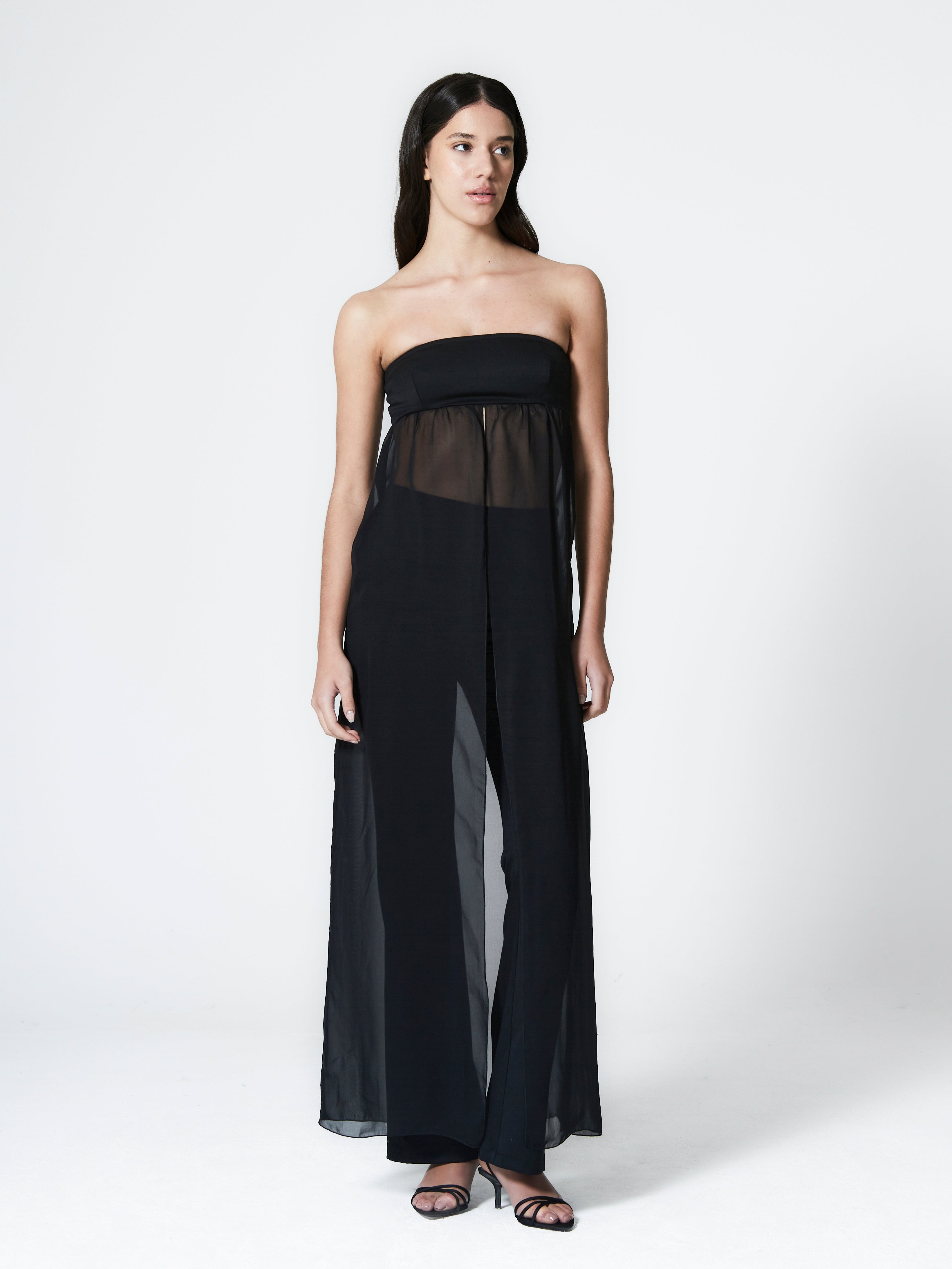 A model wearing the guilietta top in a white background. Made from fine and stretch deadstock wool paired with deadstock soft sheer viscose chiffon