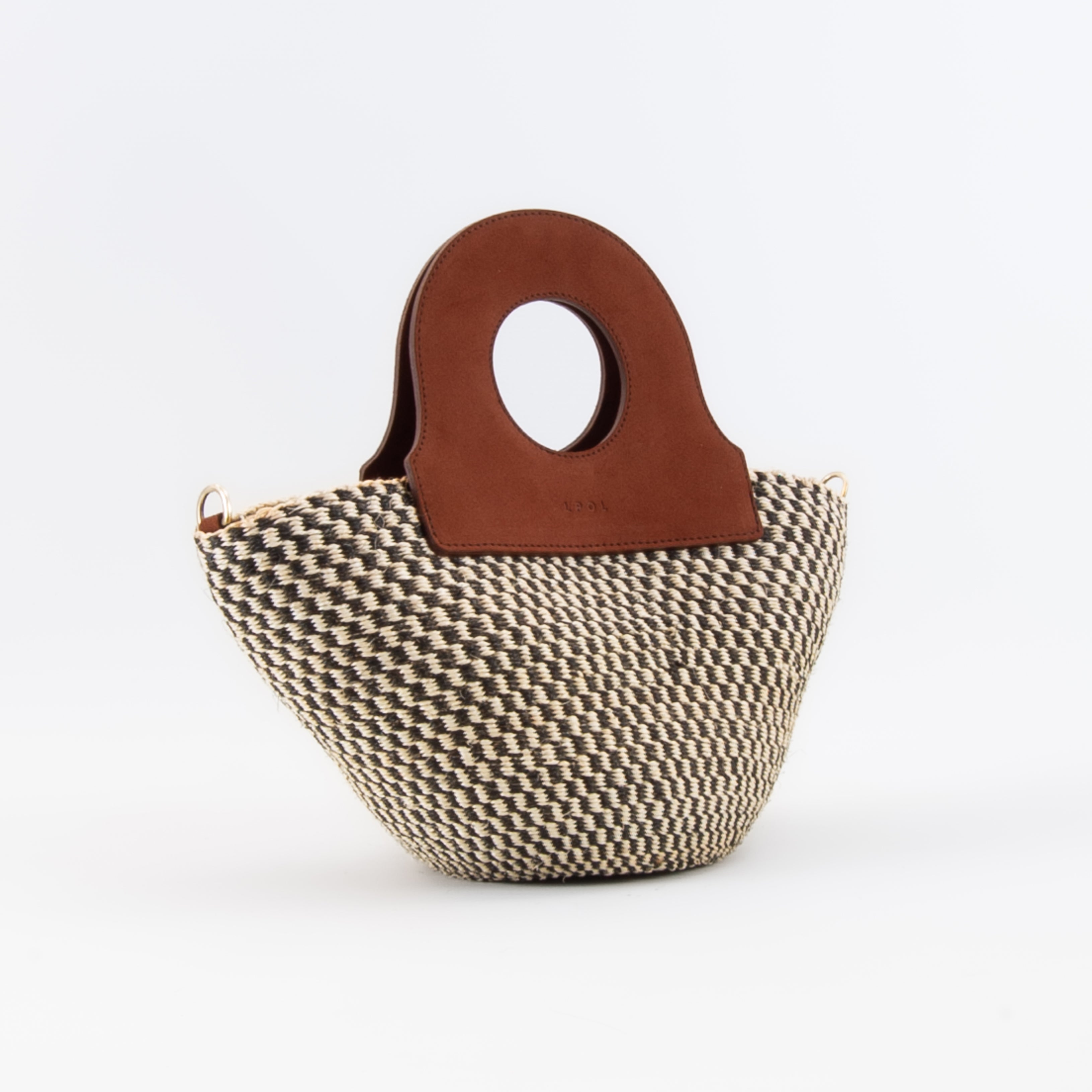 The handheld basket bag in a white background. Handwoven sisal basket made in Kenya. Finished in England using chrome-free leather.