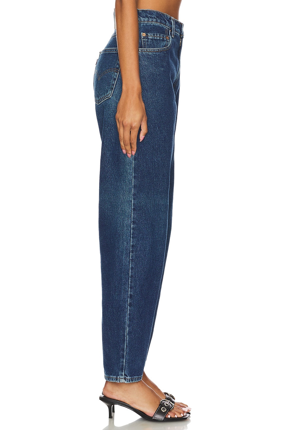 Model wearing the high rise slim customs in a white background. 100% made from repurposed Levi’s.