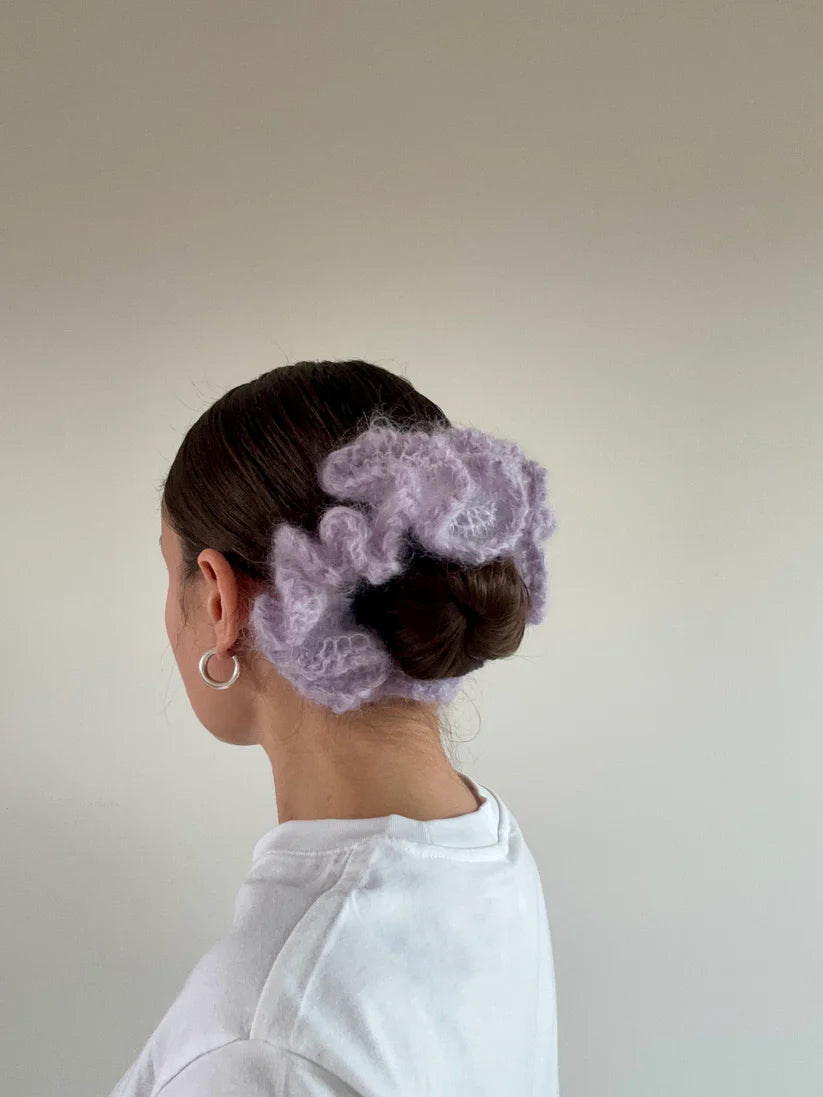 A model wearing the kayla scrunchie in a white background. Handmade in London!