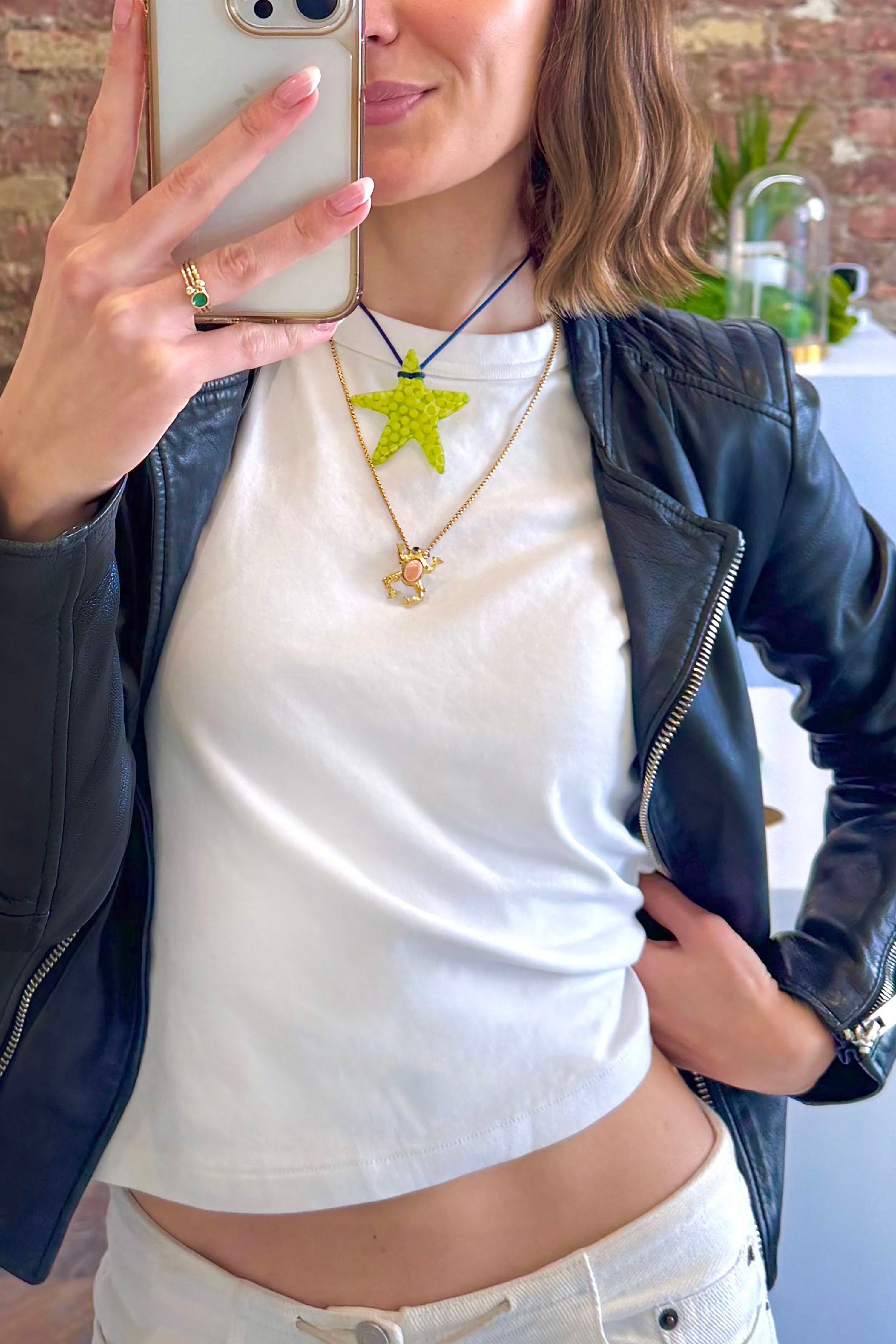 A model wearing the lime star charm . Charm are 3D printed and hand finished. Made in New York