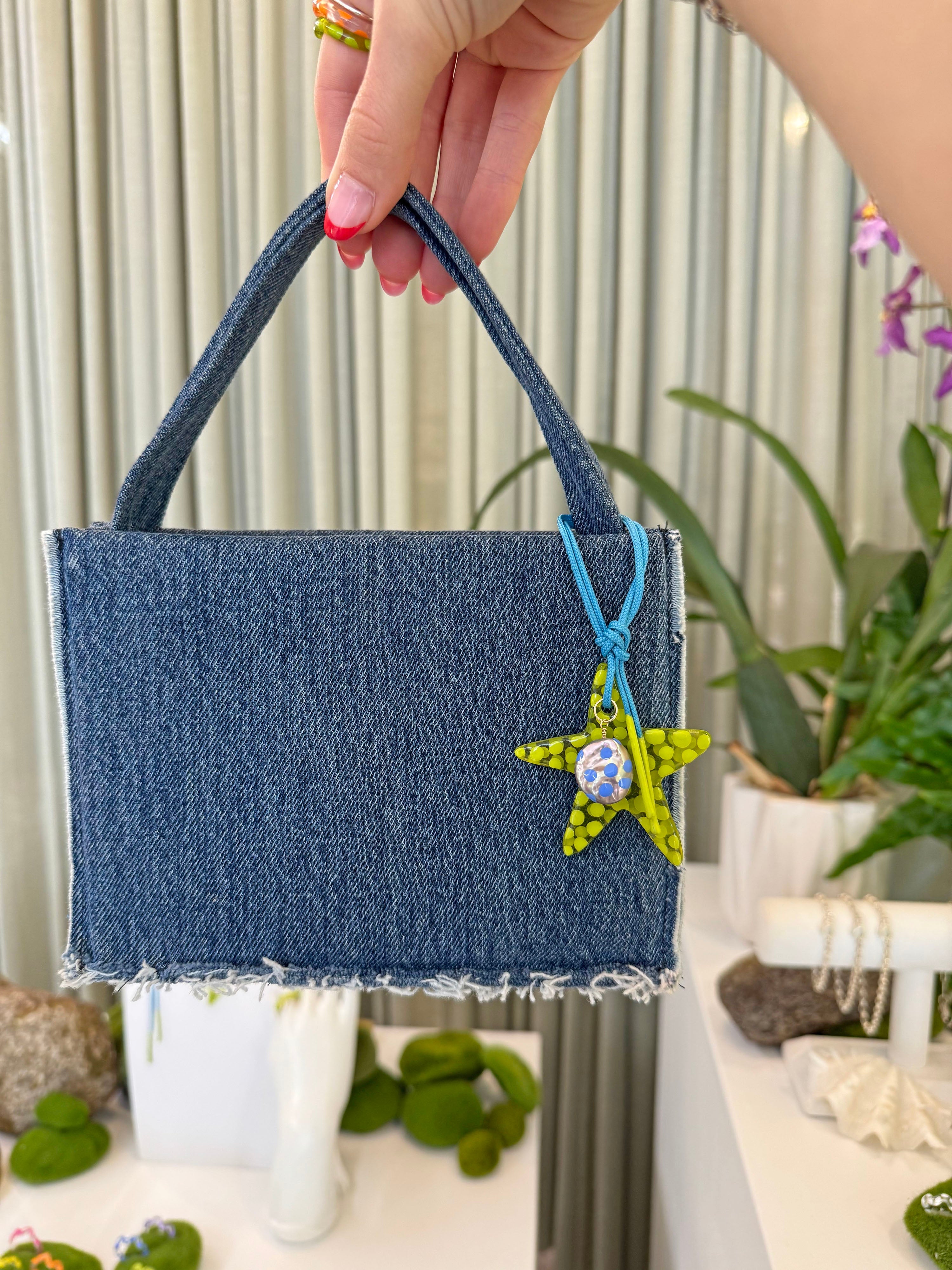 The lime star charm on a bag. Charm are 3D printed and hand finished. Made in New York