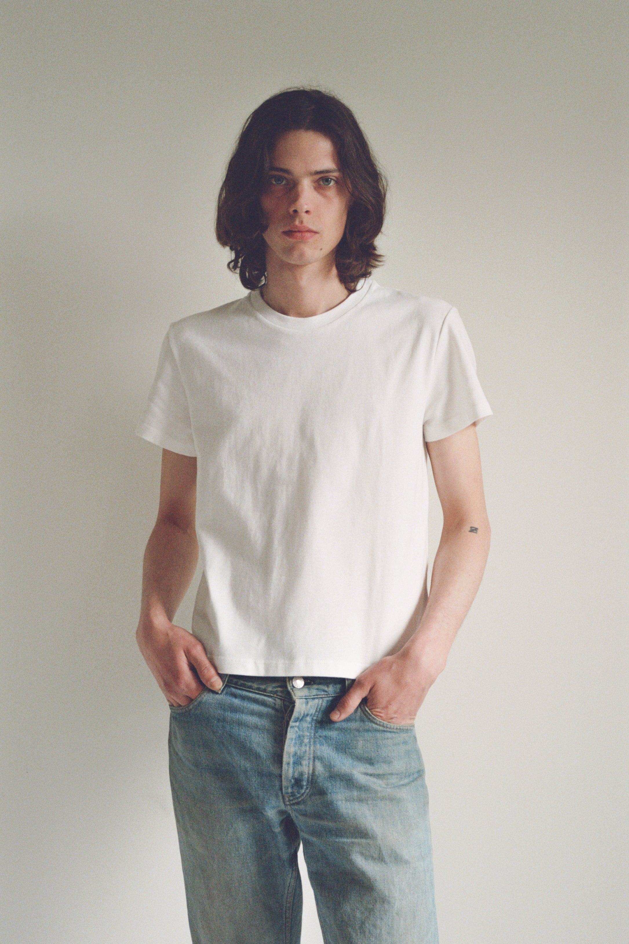 A model wearing the little tshirt in a white background. 100% made from organic grown cotton.
