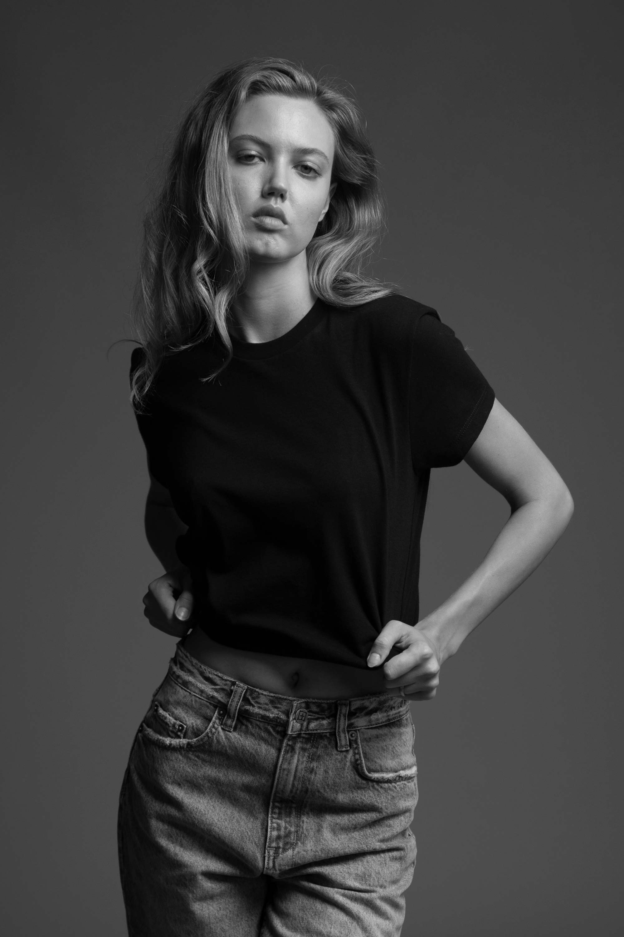 A model wearing the black little tshirt in an aesthetically background. 100% made from organic grown cotton.