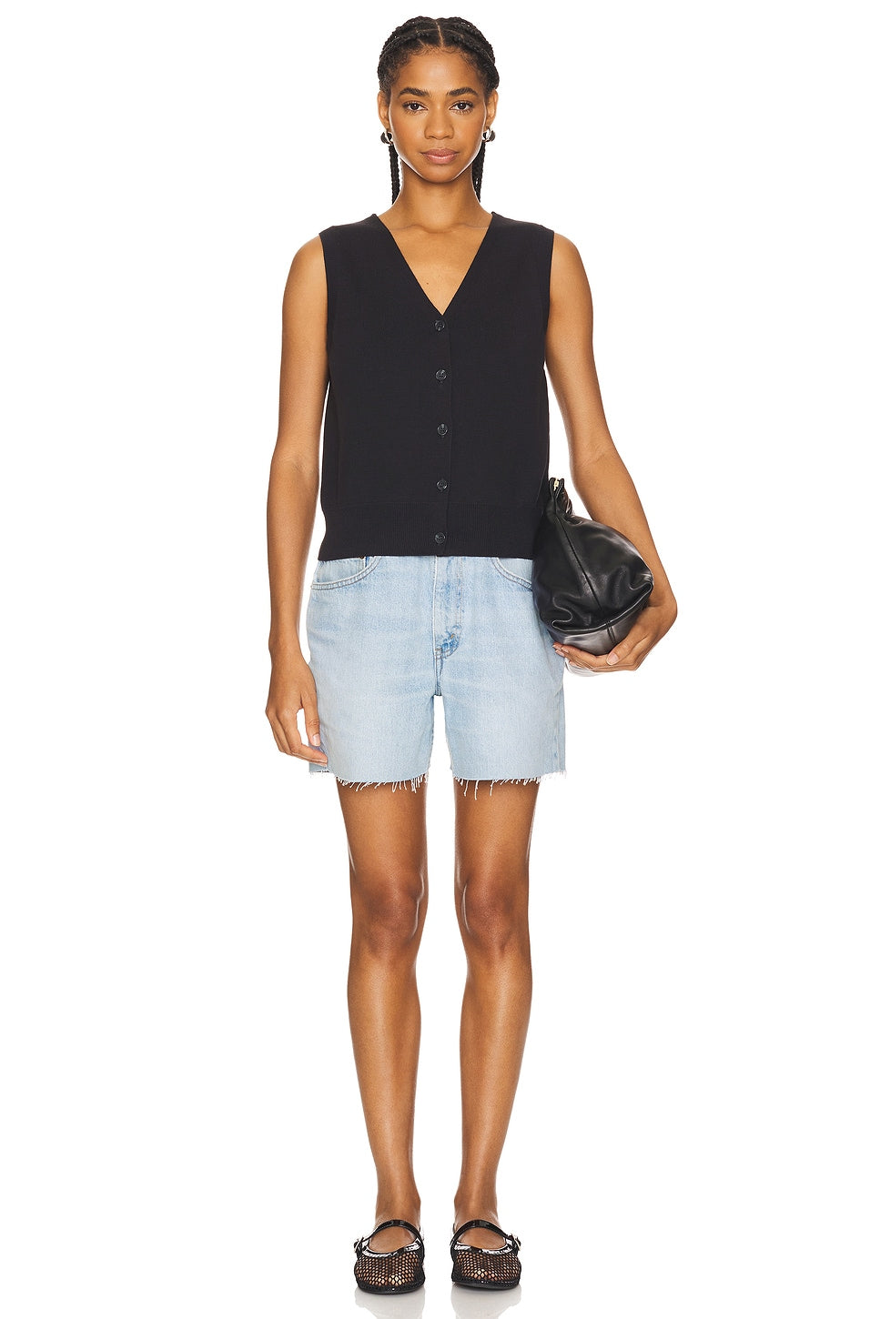 Model wearing a long baggy short in a white background. 100% made from repurposed Levi’s.