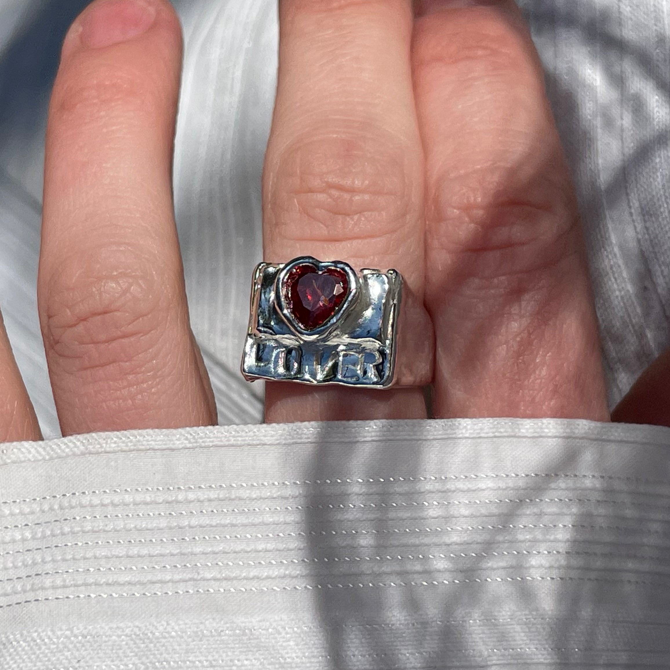 The lover ring in a white background. Made from 100% recycled metals and lab created gemstones. CLOSE UP