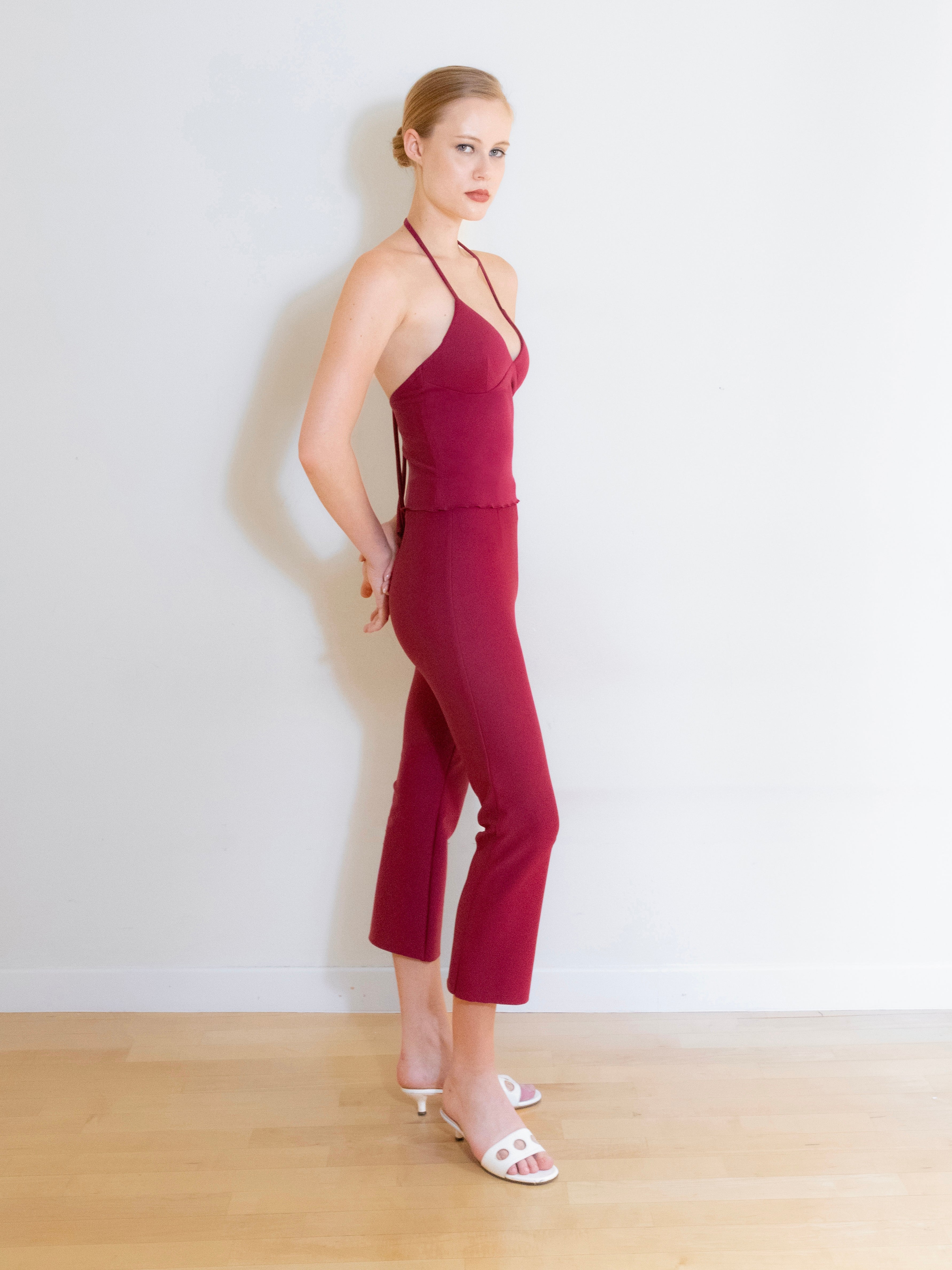 A model wearing the Luna knit capri pants in a white background. Made from soft, stretchy deadstock fabric