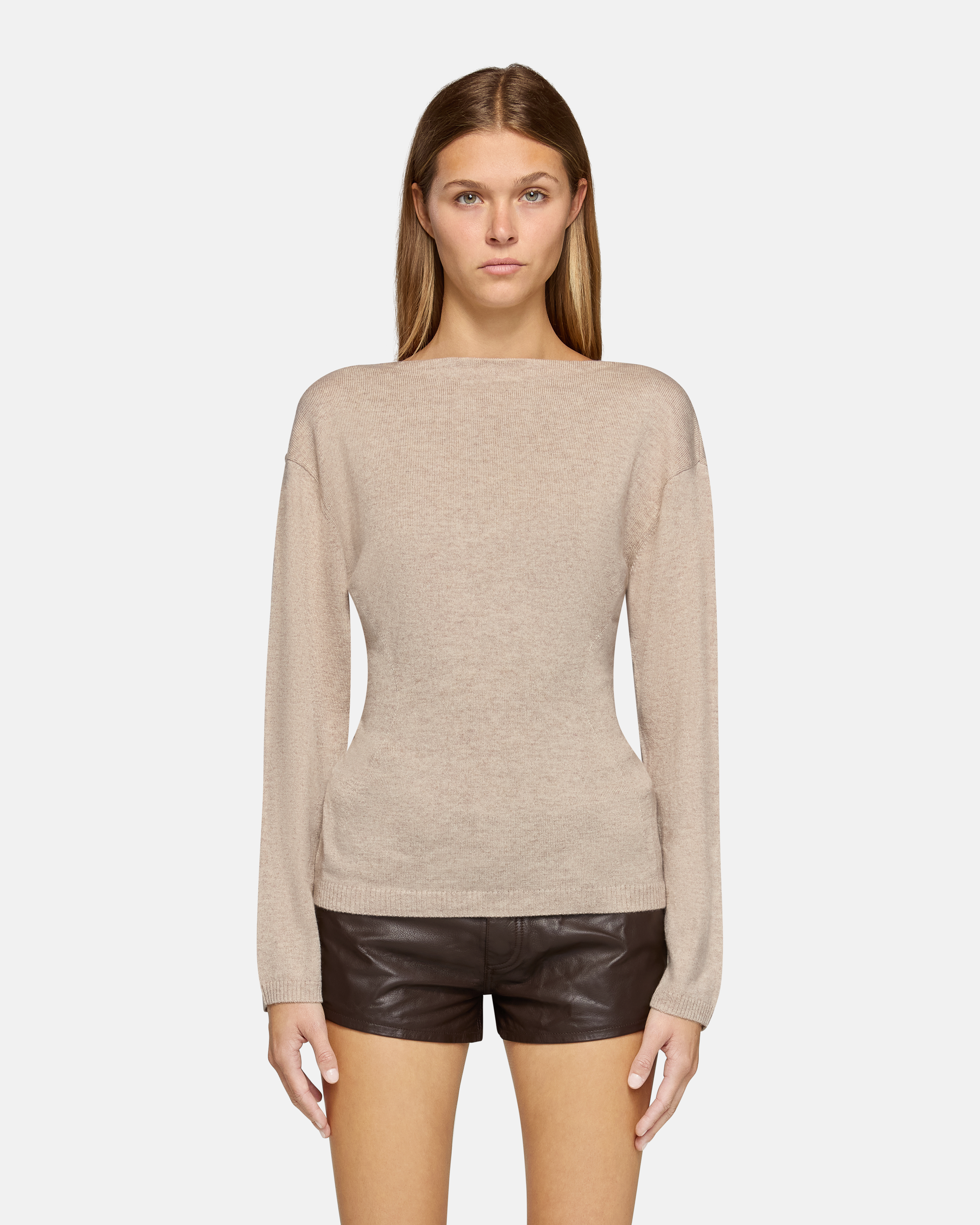 A model wearing the millie boat neck sweater in oatmeal in a white background. 100% made from cotton.