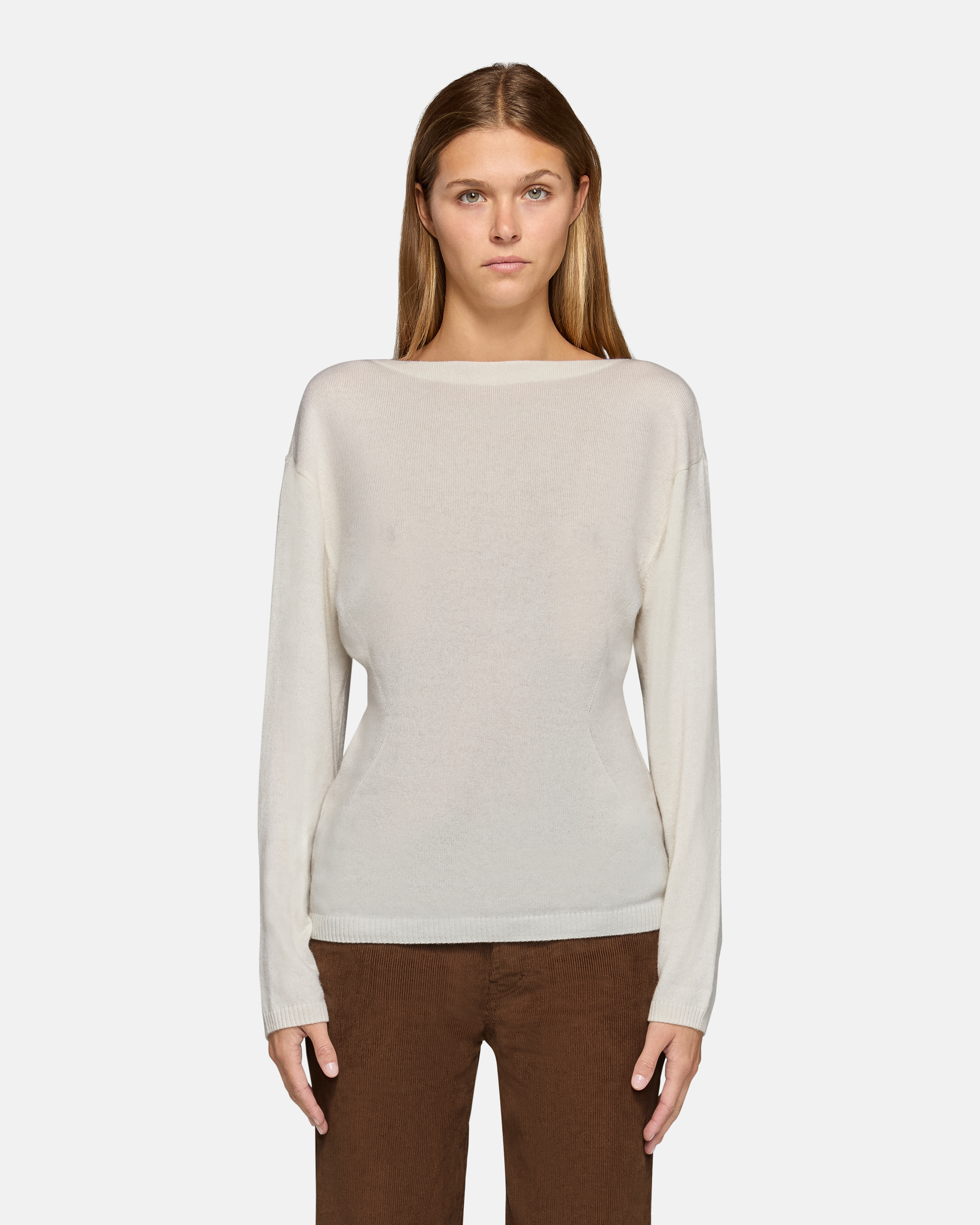 A model wearing the millie boat neck sweater in white in a white background. 100% made from cotton.