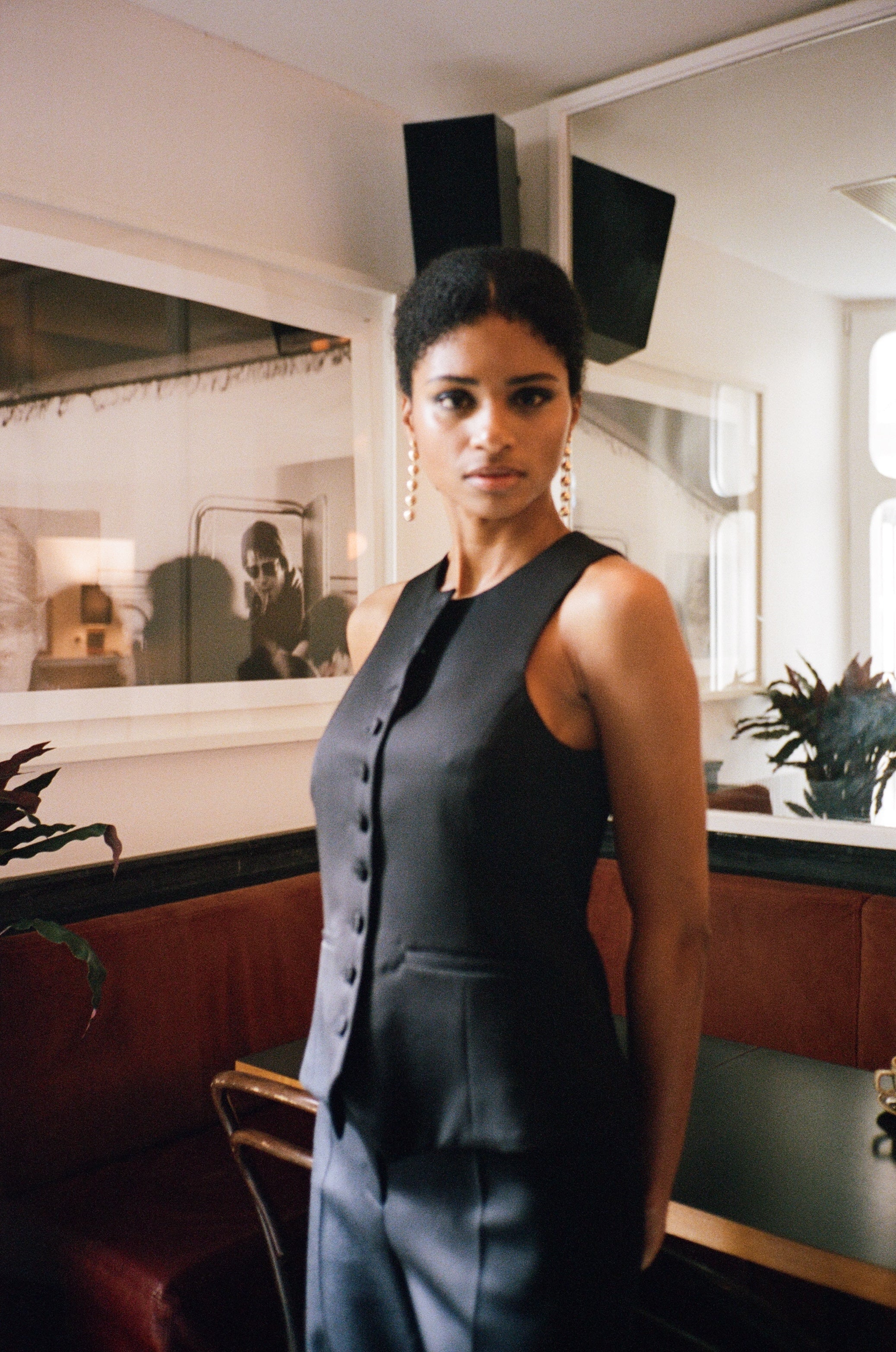 A model wearing the monica wool and black satin best in an aesthetically background. 100% upcycled GOTS Linen.