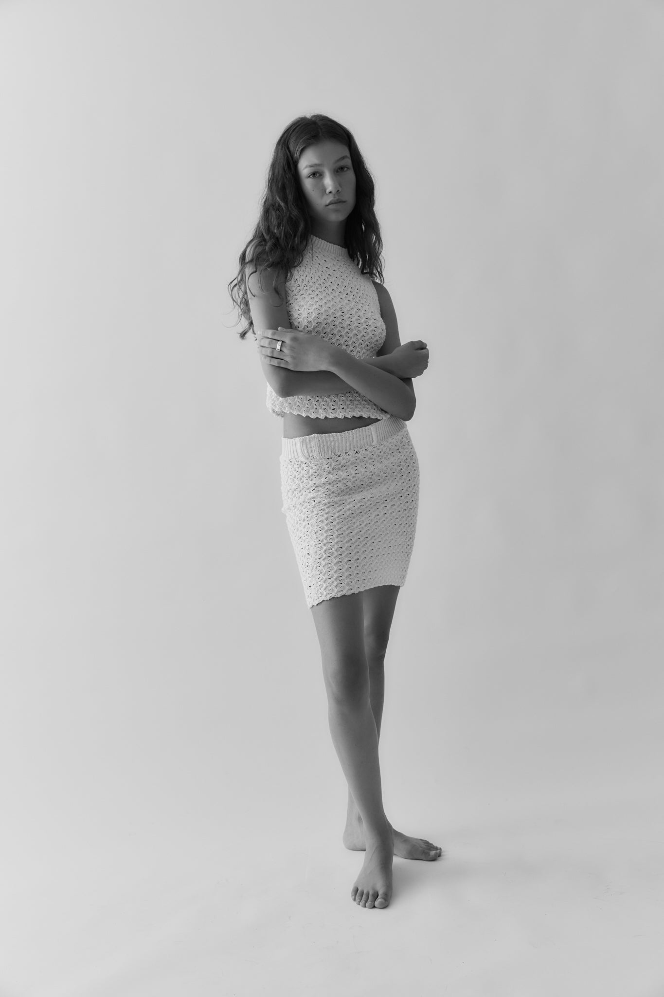 A model wearing the noa skirt in a white background. 100% white cotton knit.